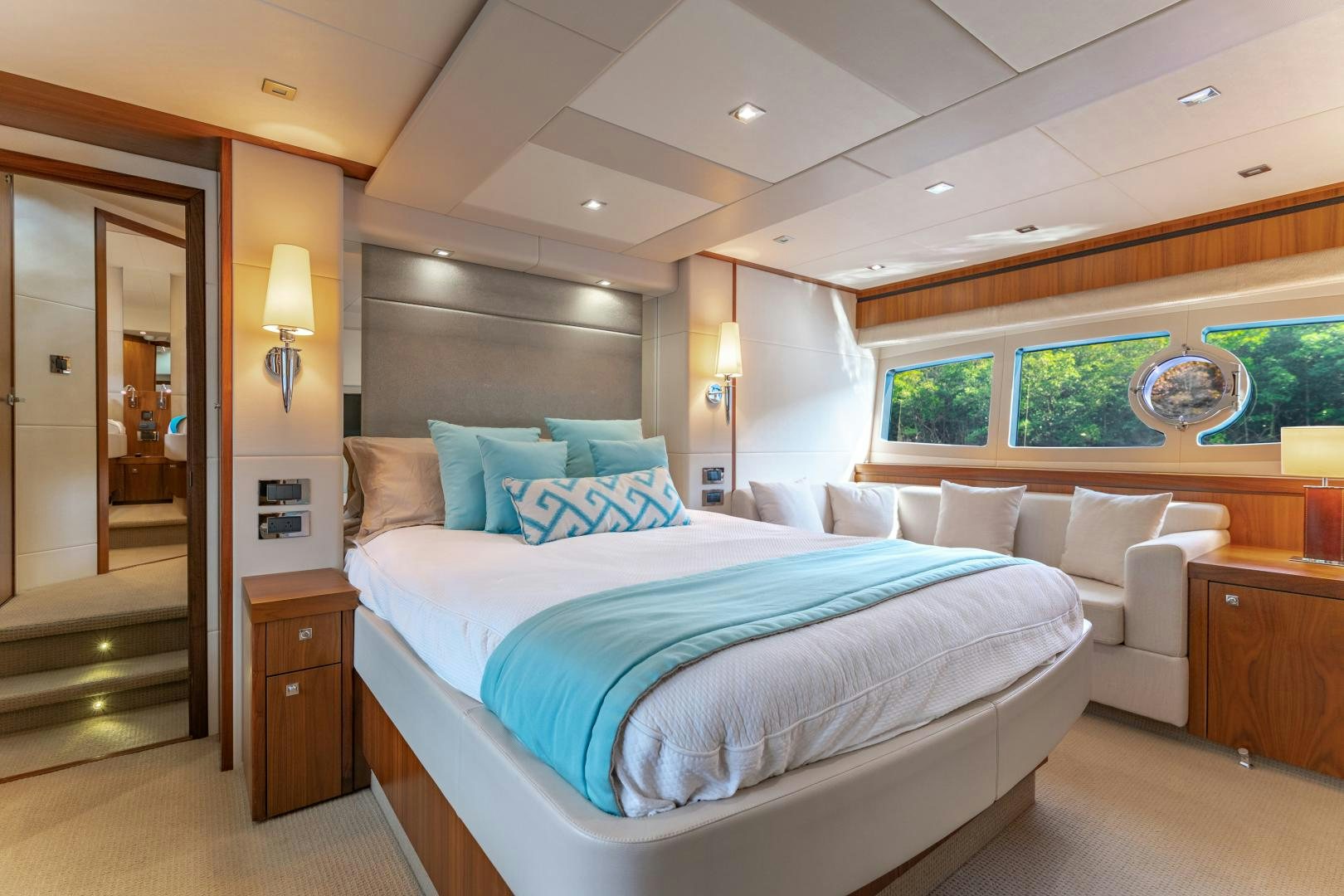 a bedroom with a bed and a couch aboard SOL Y LUNA Yacht for Sale