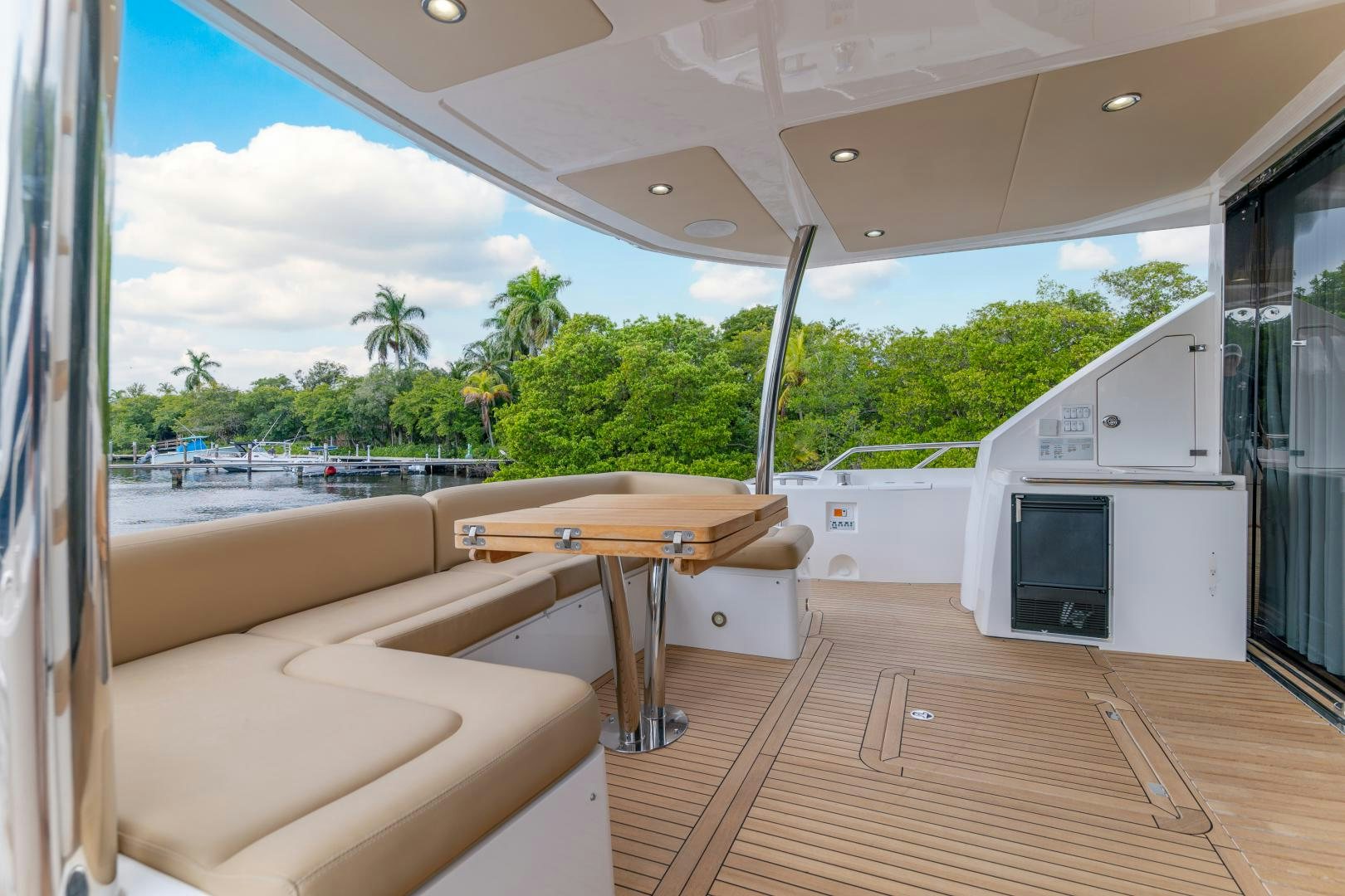 a deck with a table and chairs aboard SOL Y LUNA Yacht for Sale