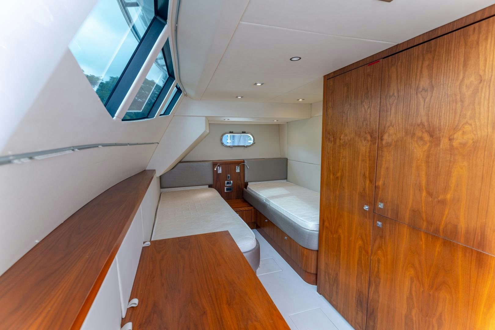 a room with a wood floor and a wood cabinet aboard SOL Y LUNA Yacht for Sale