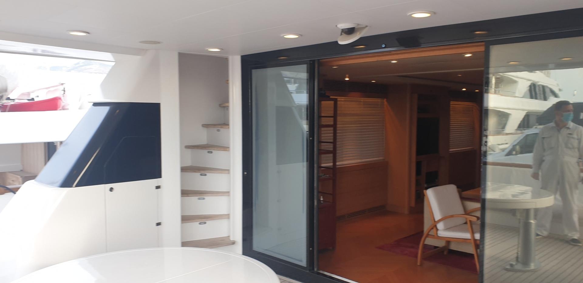 a person in a white coat in a room with a table and chairs aboard TIGRA Yacht for Sale