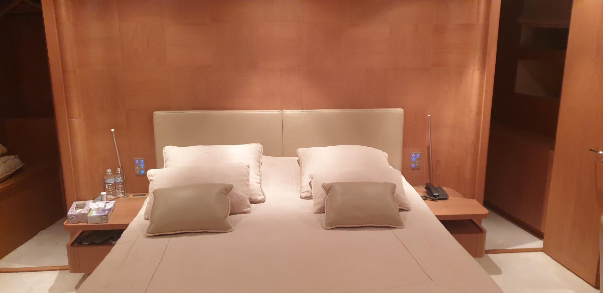 a bed with white sheets aboard TIGRA Yacht for Sale