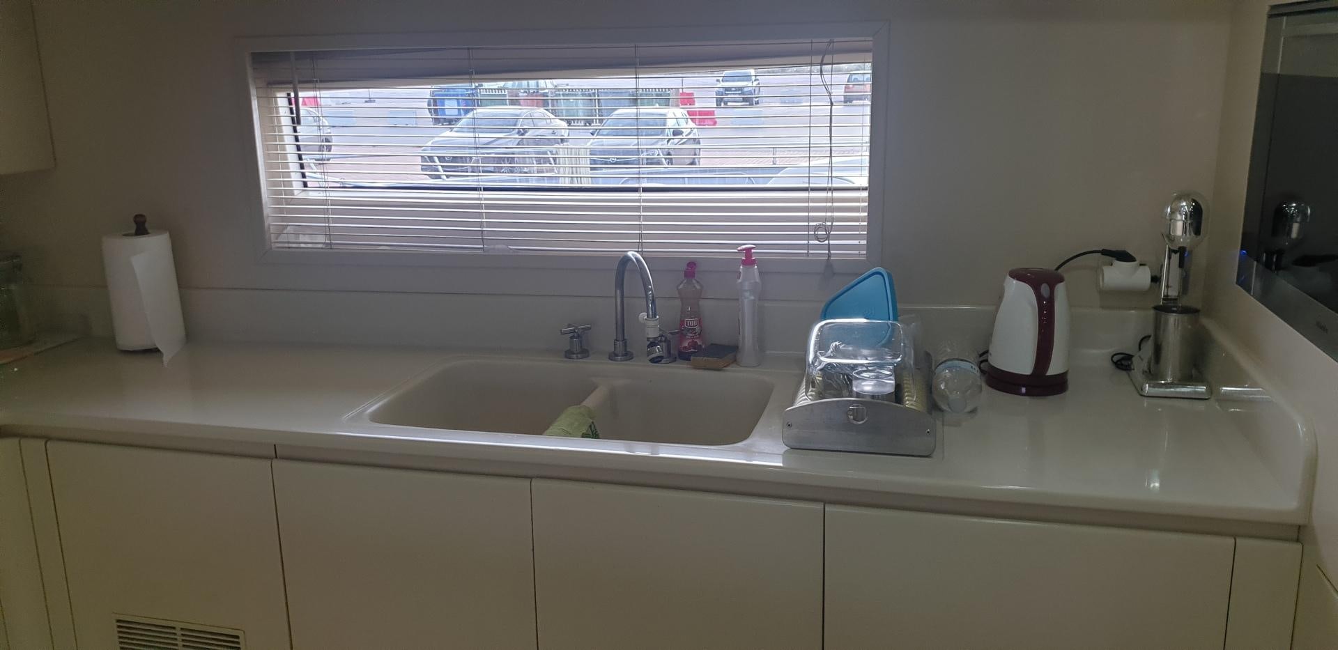a bathroom sink with a window aboard TIGRA Yacht for Sale