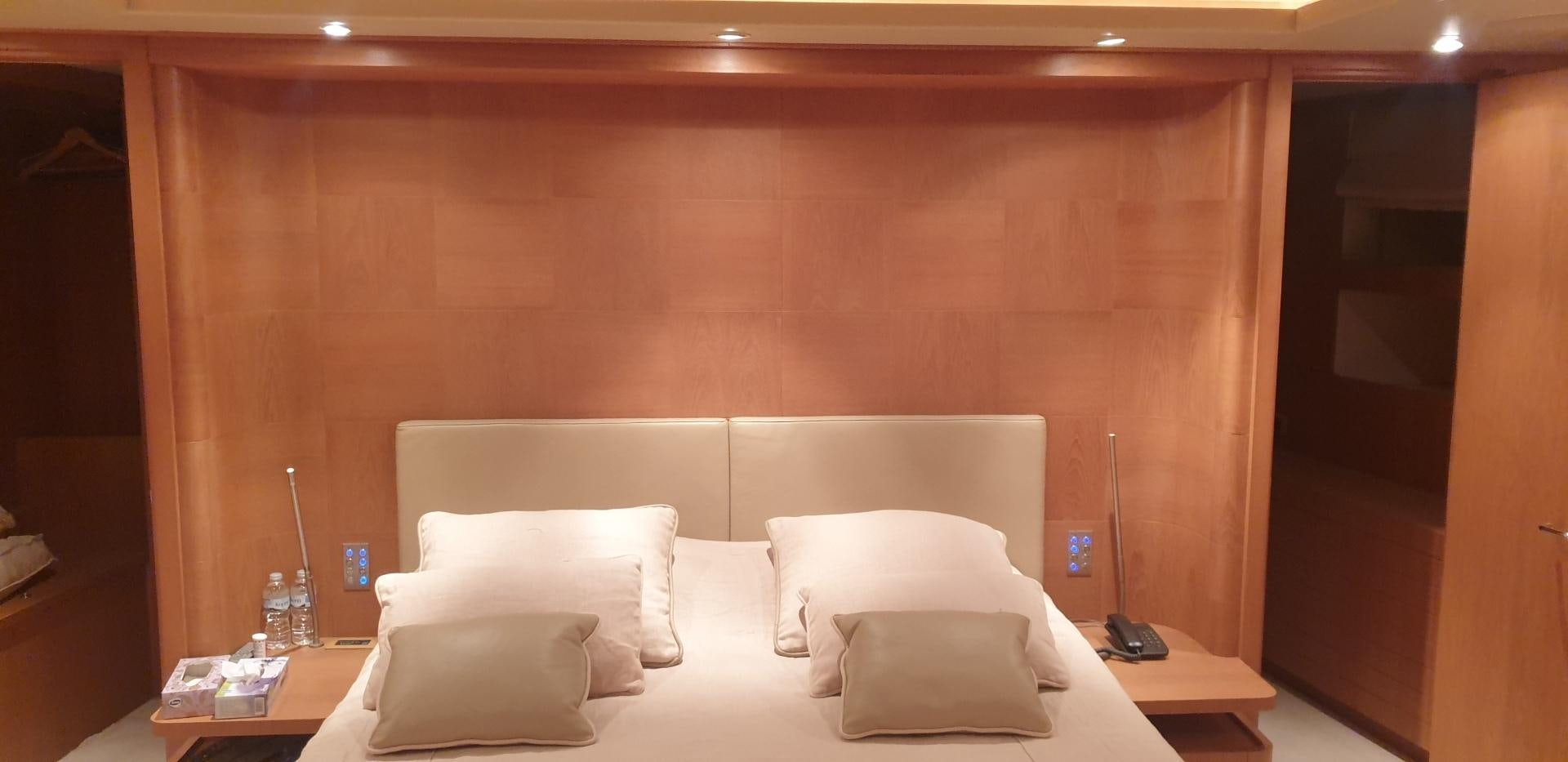 a room with a bed and a desk aboard TIGRA Yacht for Sale