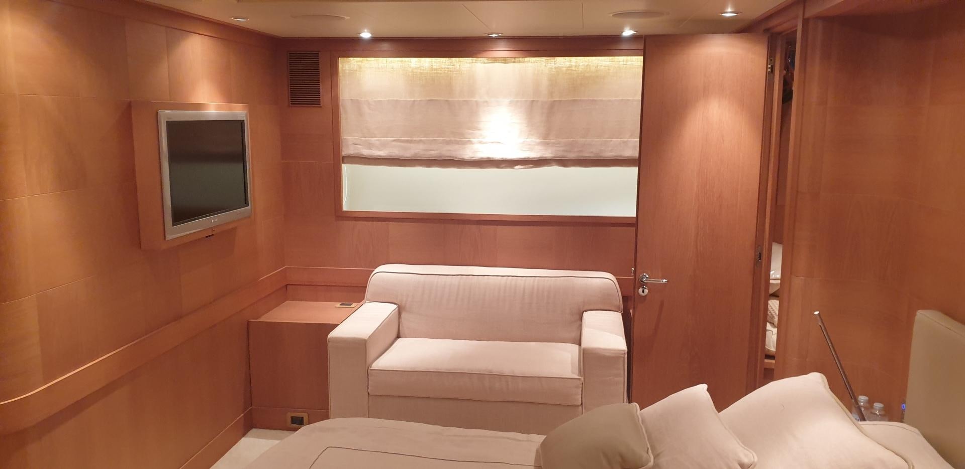 a room with a couch and a television aboard TIGRA Yacht for Sale