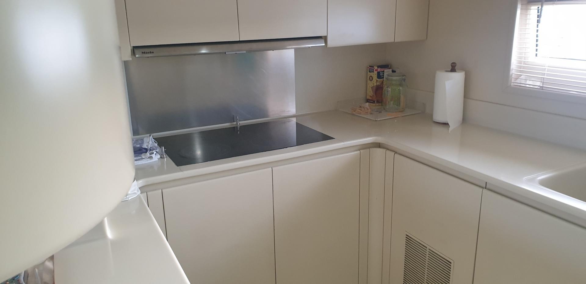 a kitchen with a sink and cabinets aboard TIGRA Yacht for Sale