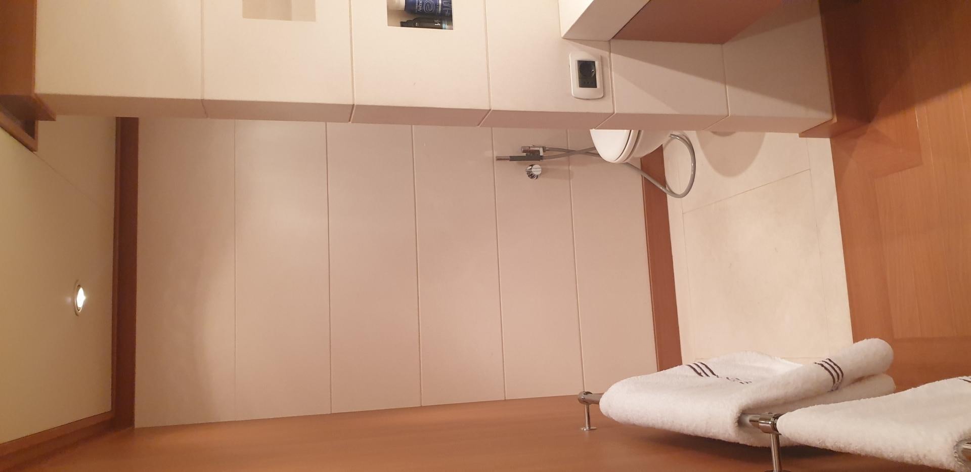 a room with a bed and a lamp aboard TIGRA Yacht for Sale