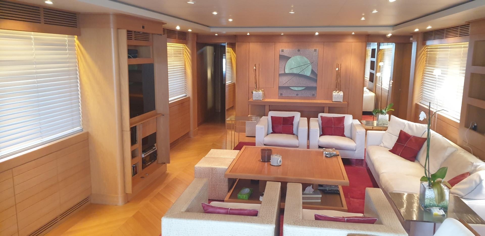 a living room with a table and chairs aboard TIGRA Yacht for Sale