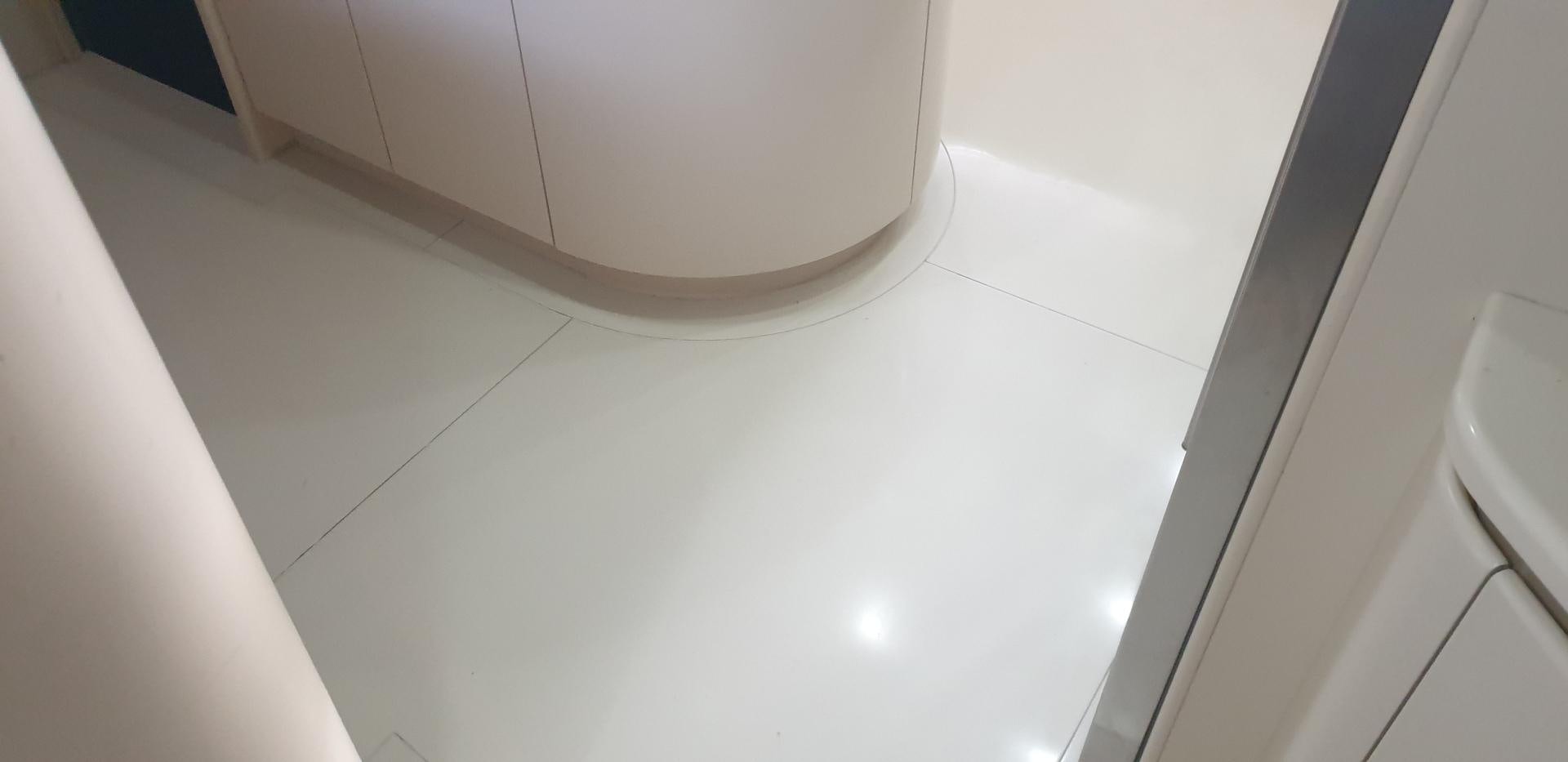 a white bathroom with a white tile floor aboard TIGRA Yacht for Sale