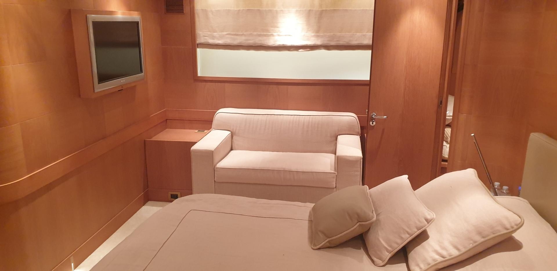 a room with a bed and a television aboard TIGRA Yacht for Sale