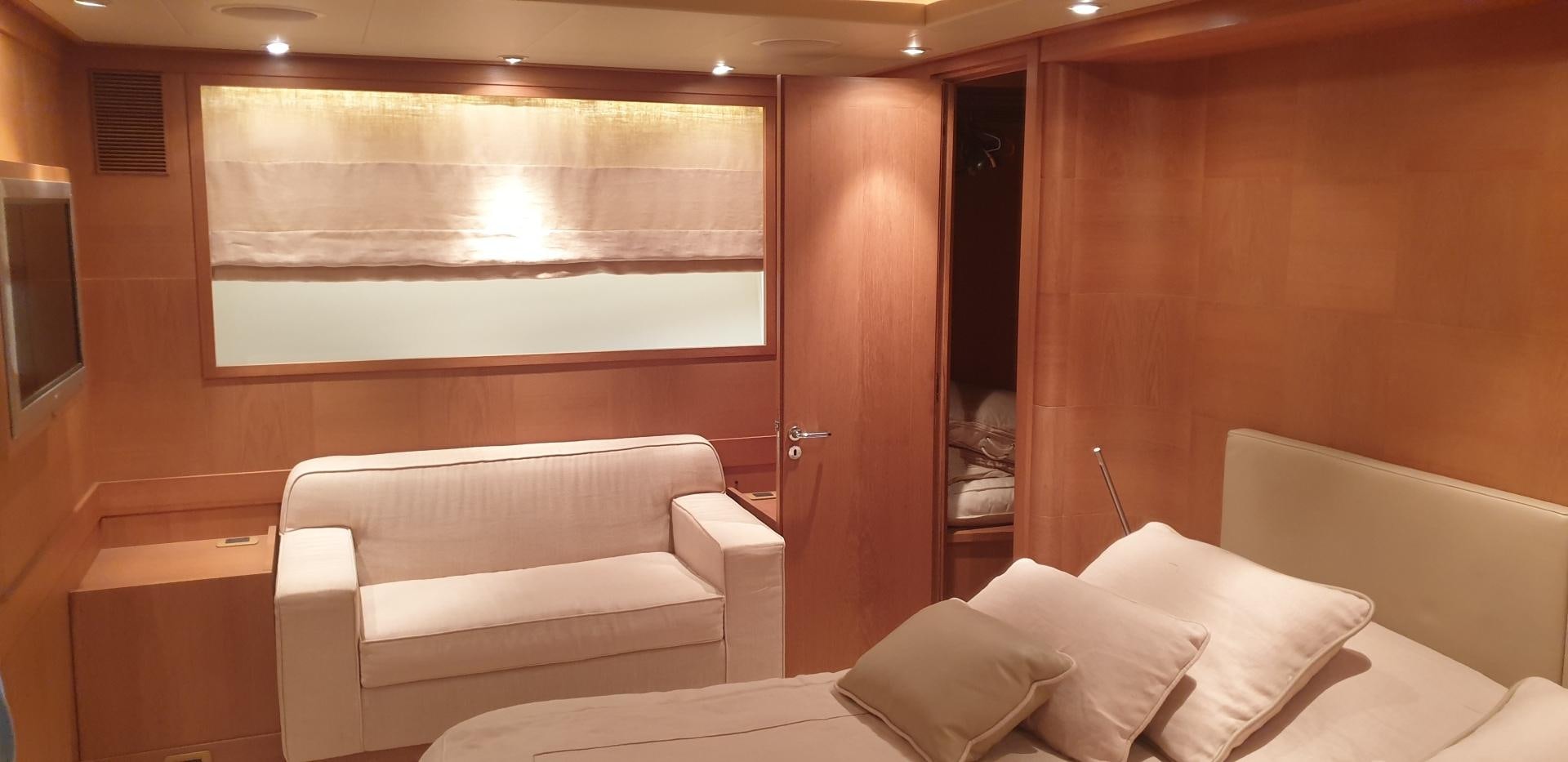 a room with a bed and a couch aboard TIGRA Yacht for Sale