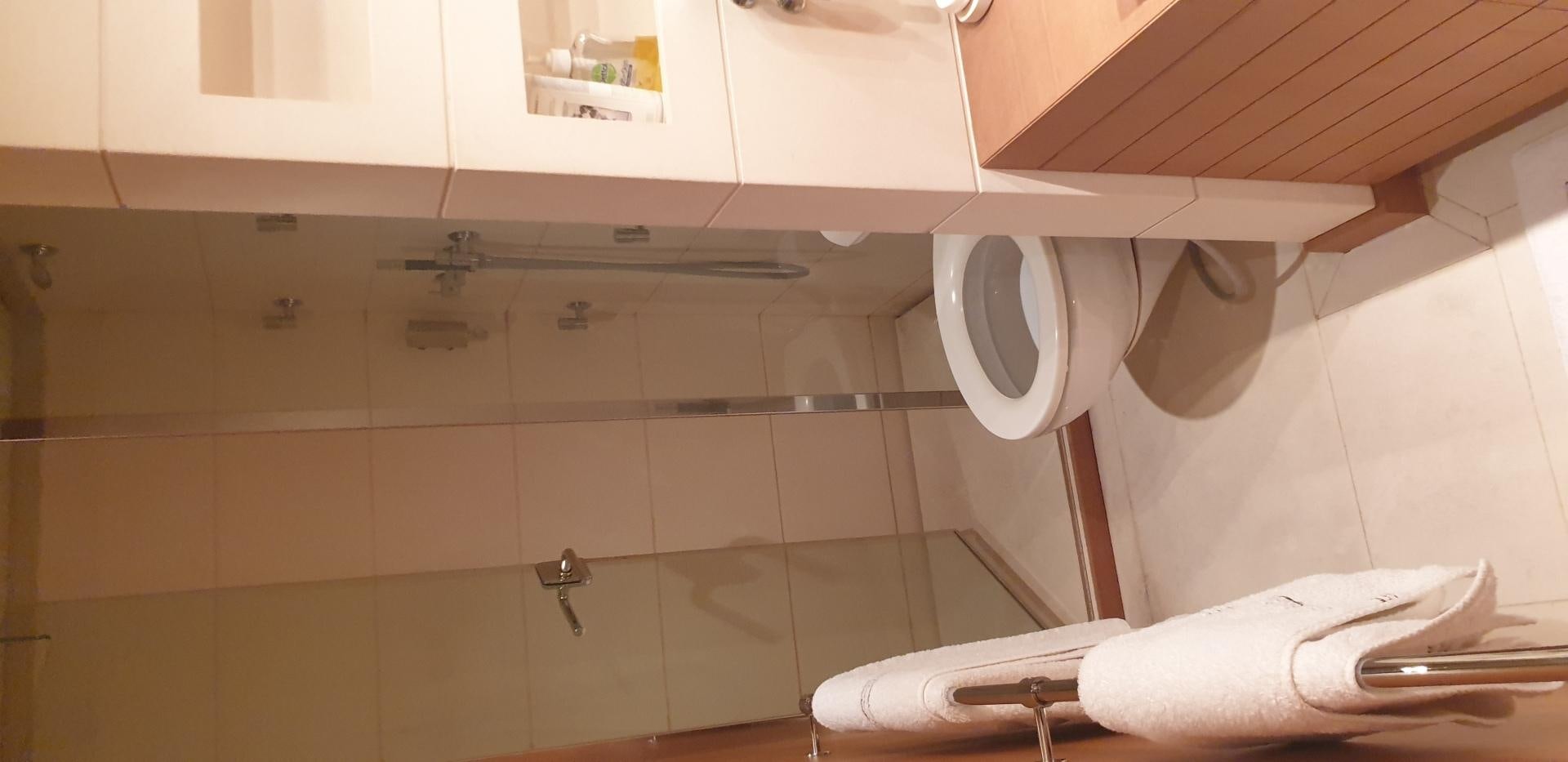 a person's hand holding a roll of toilet paper aboard TIGRA Yacht for Sale