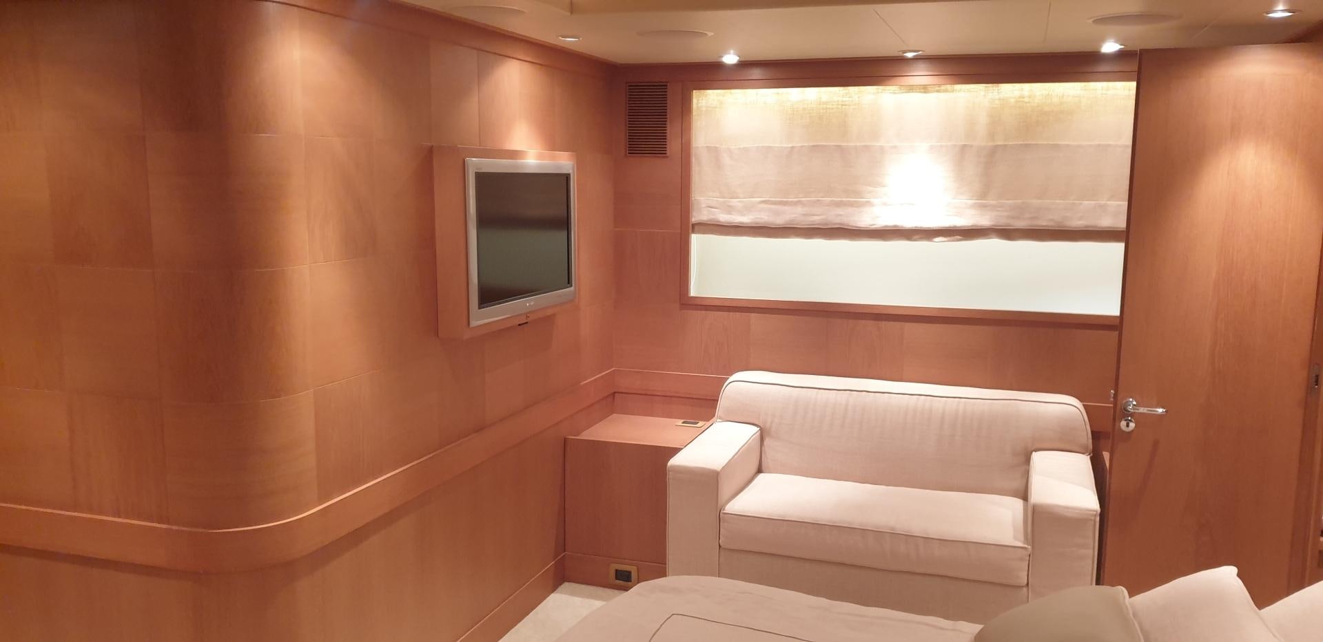 a room with a couch and a television aboard TIGRA Yacht for Sale