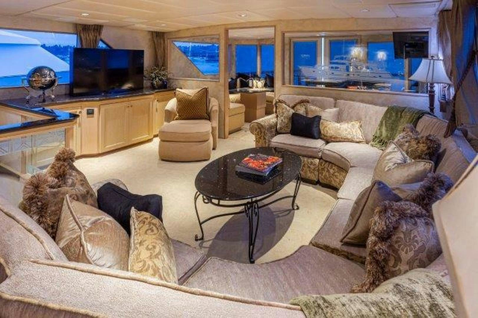 a living room with a large sofa and a coffee table aboard ANDIAMO Yacht for Sale