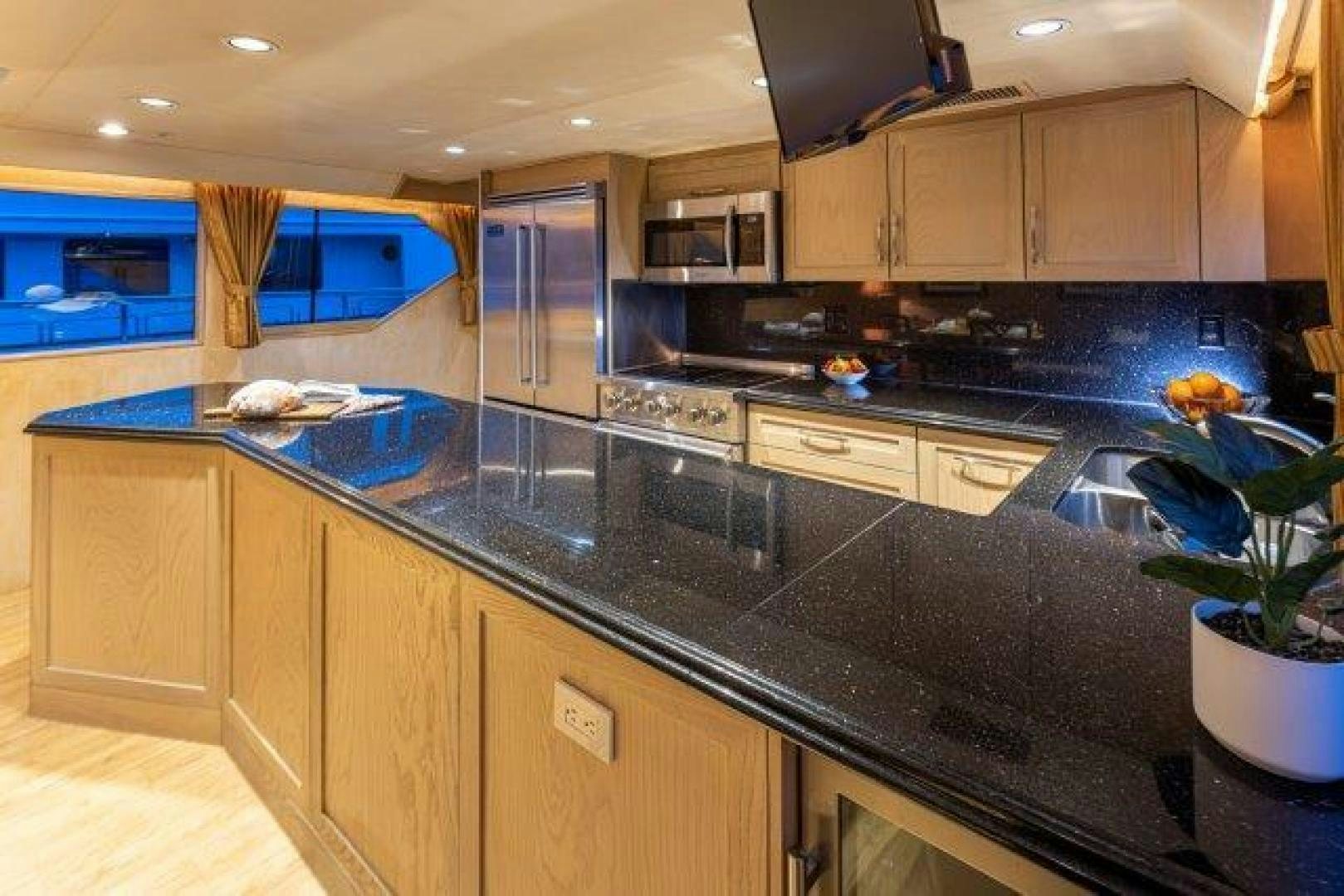 a kitchen with a large island aboard ANDIAMO Yacht for Sale