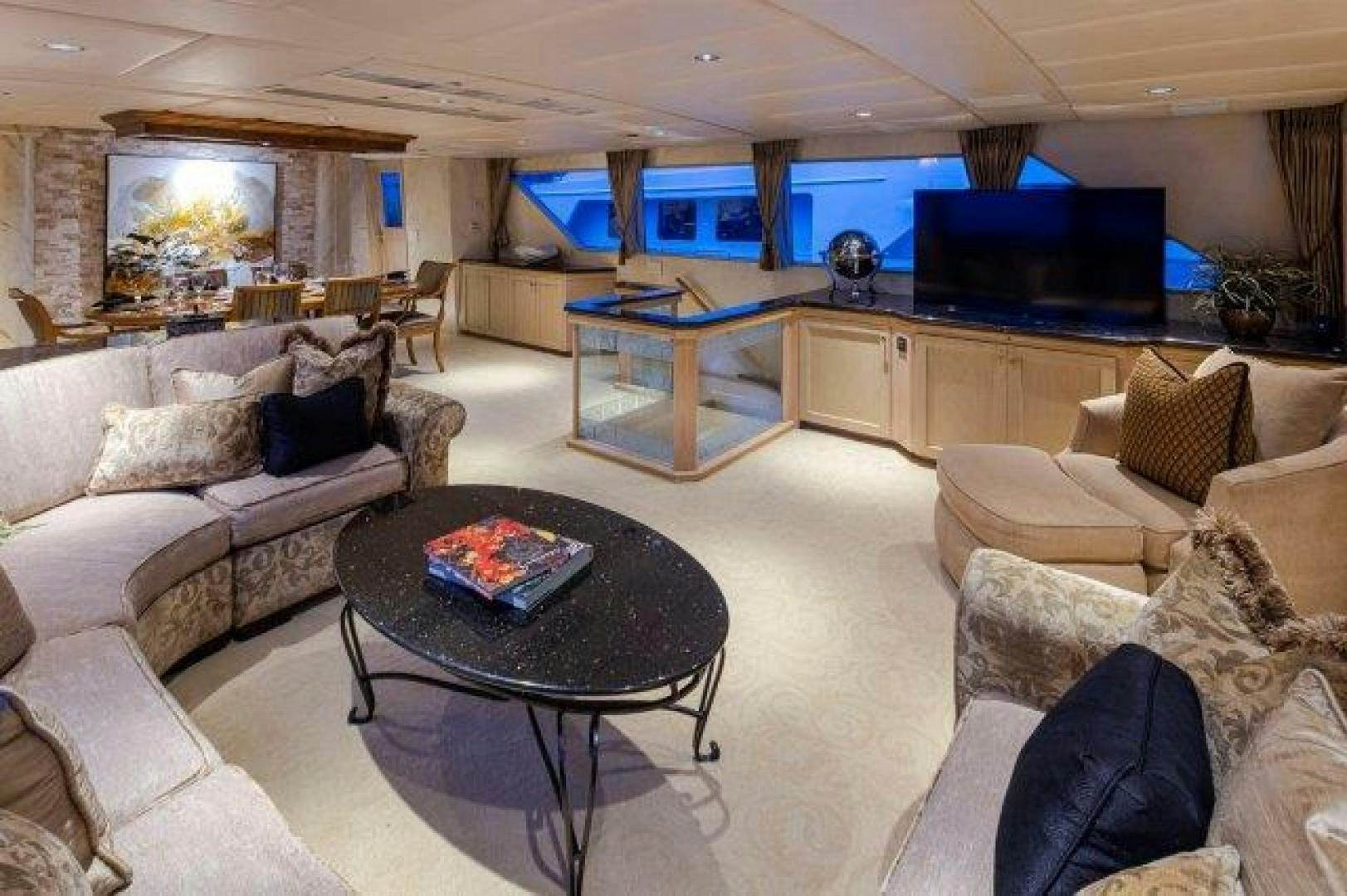 a living room with a large screen aboard ANDIAMO Yacht for Sale
