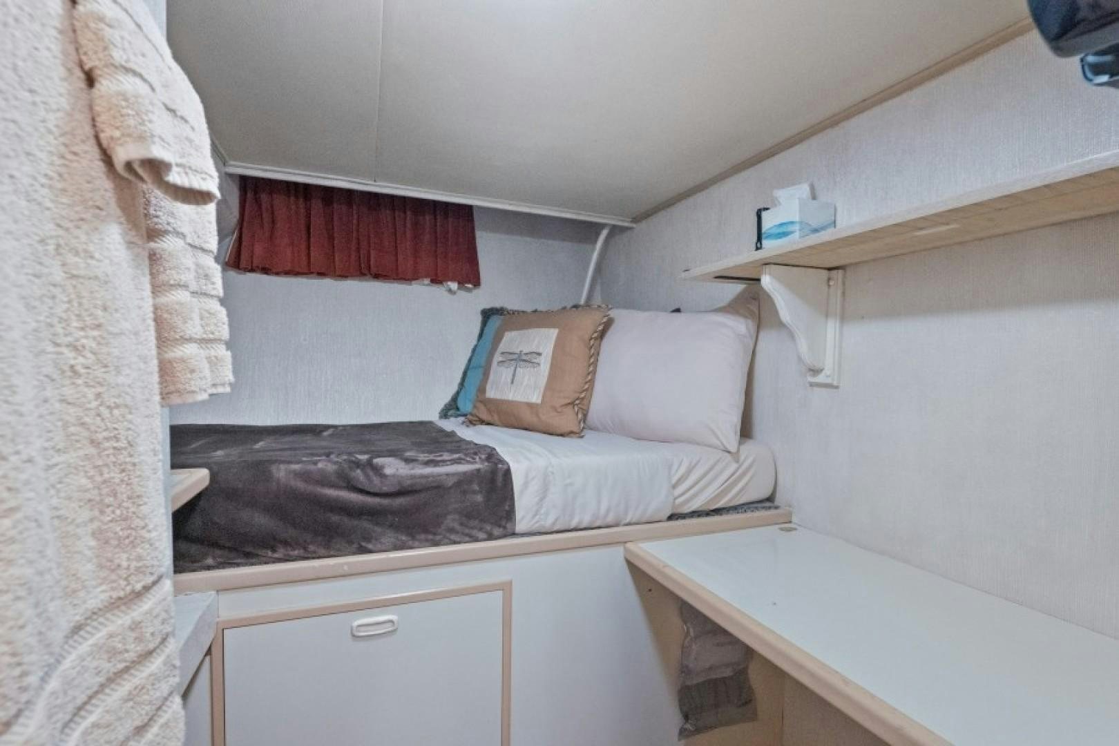 a room with a bed and a desk aboard ANDIAMO Yacht for Sale
