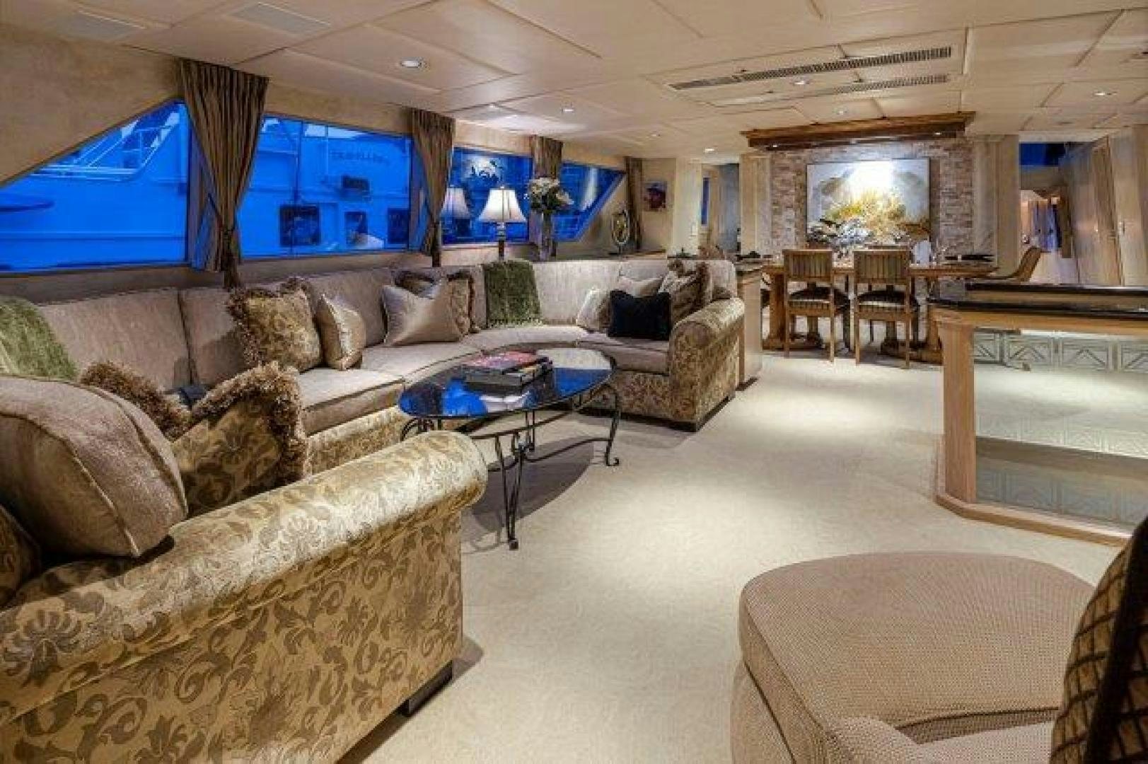 a living room with a couch and a table aboard ANDIAMO Yacht for Sale