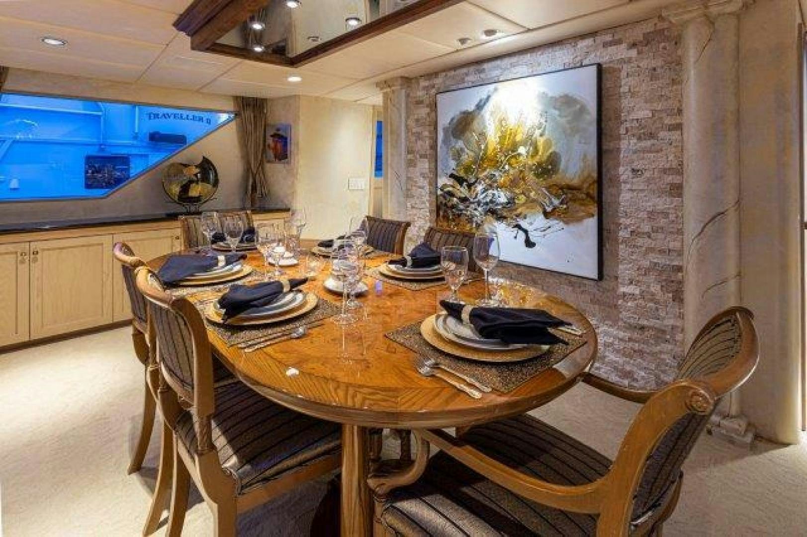 a dining table with plates and glasses aboard ANDIAMO Yacht for Sale