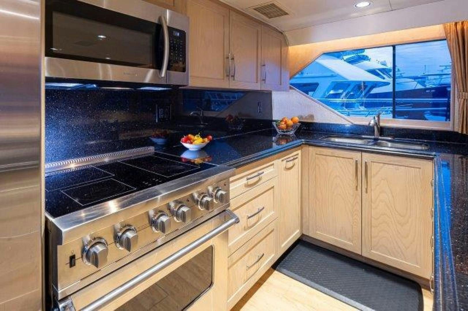 a kitchen with a stove and microwave aboard ANDIAMO Yacht for Sale
