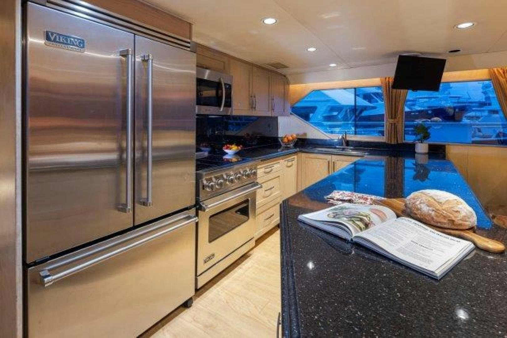 a kitchen with a microwave oven and a refrigerator aboard ANDIAMO Yacht for Sale