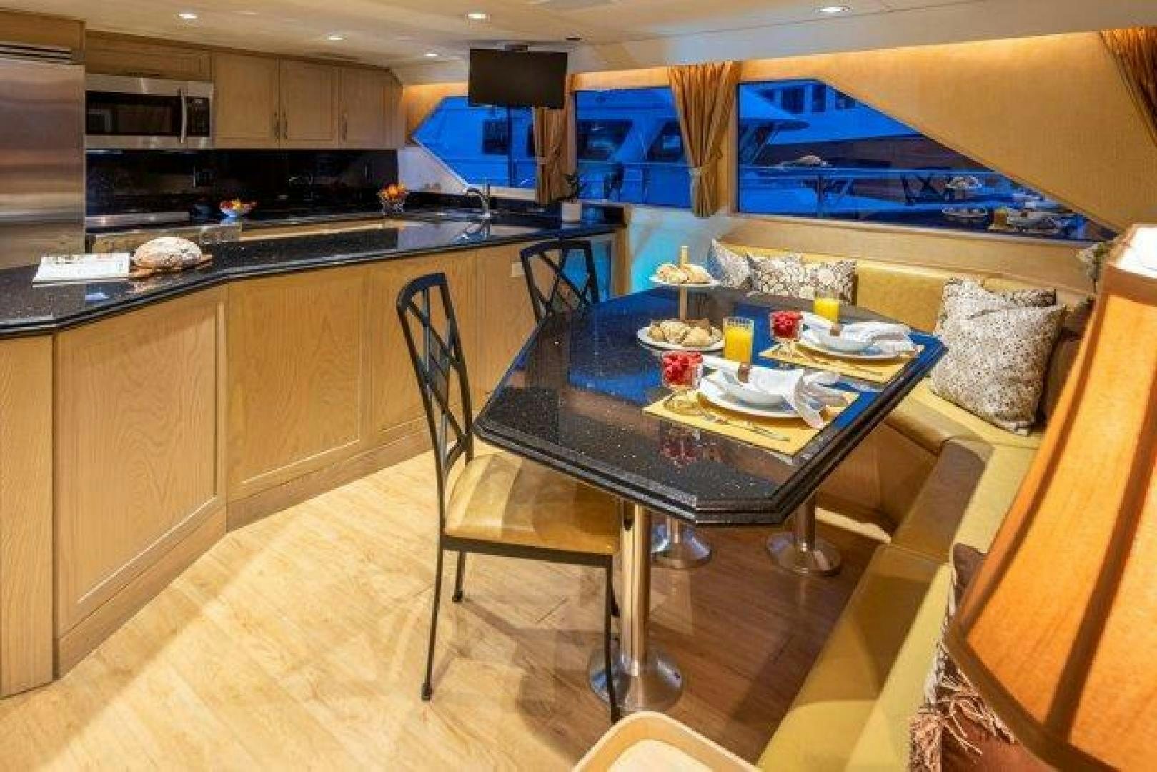 a kitchen with a table and chairs aboard ANDIAMO Yacht for Sale