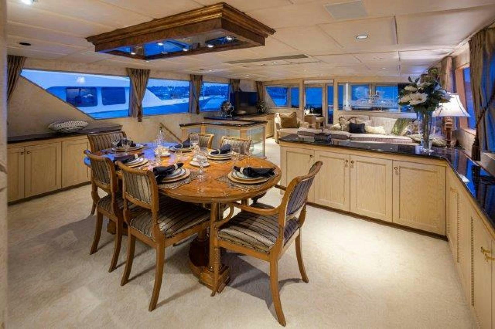 a kitchen with a table and chairs aboard ANDIAMO Yacht for Sale