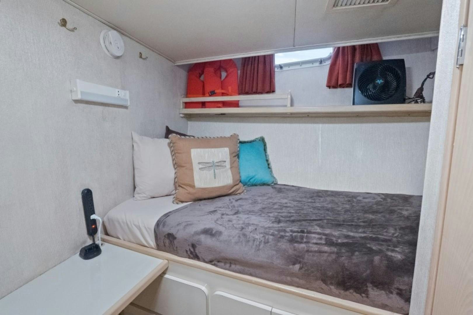 a bedroom with a bed and a desk aboard ANDIAMO Yacht for Sale