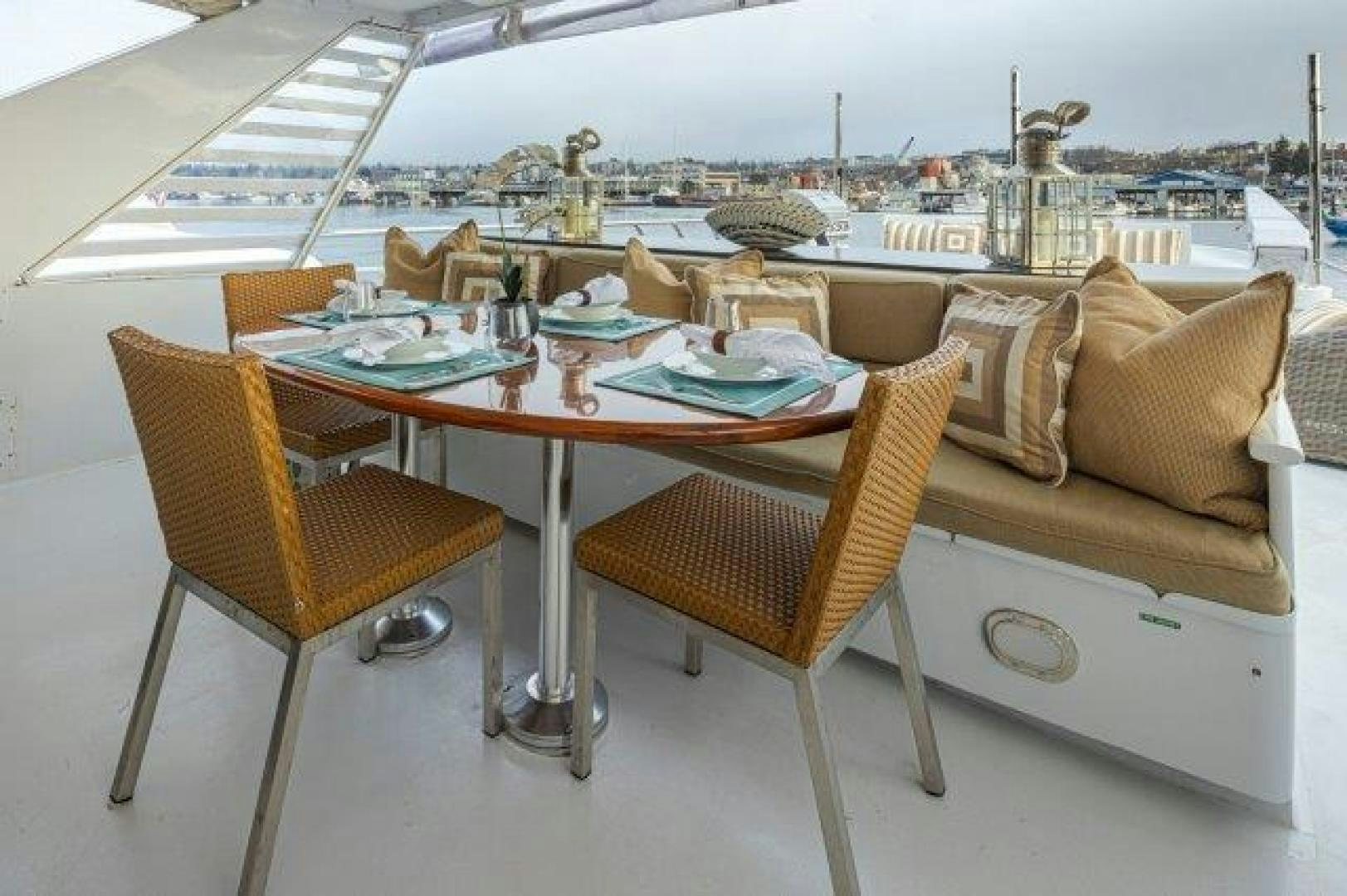 a table with chairs and a couch aboard ANDIAMO Yacht for Sale