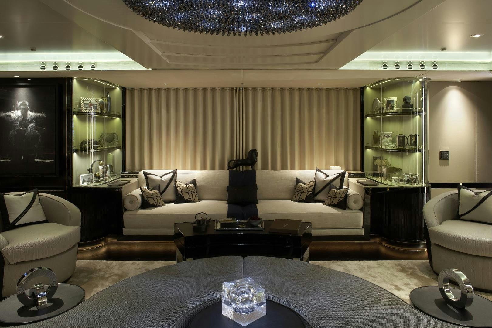 a living room with a large white couch and a large chandelier aboard SEALYON Yacht for Sale