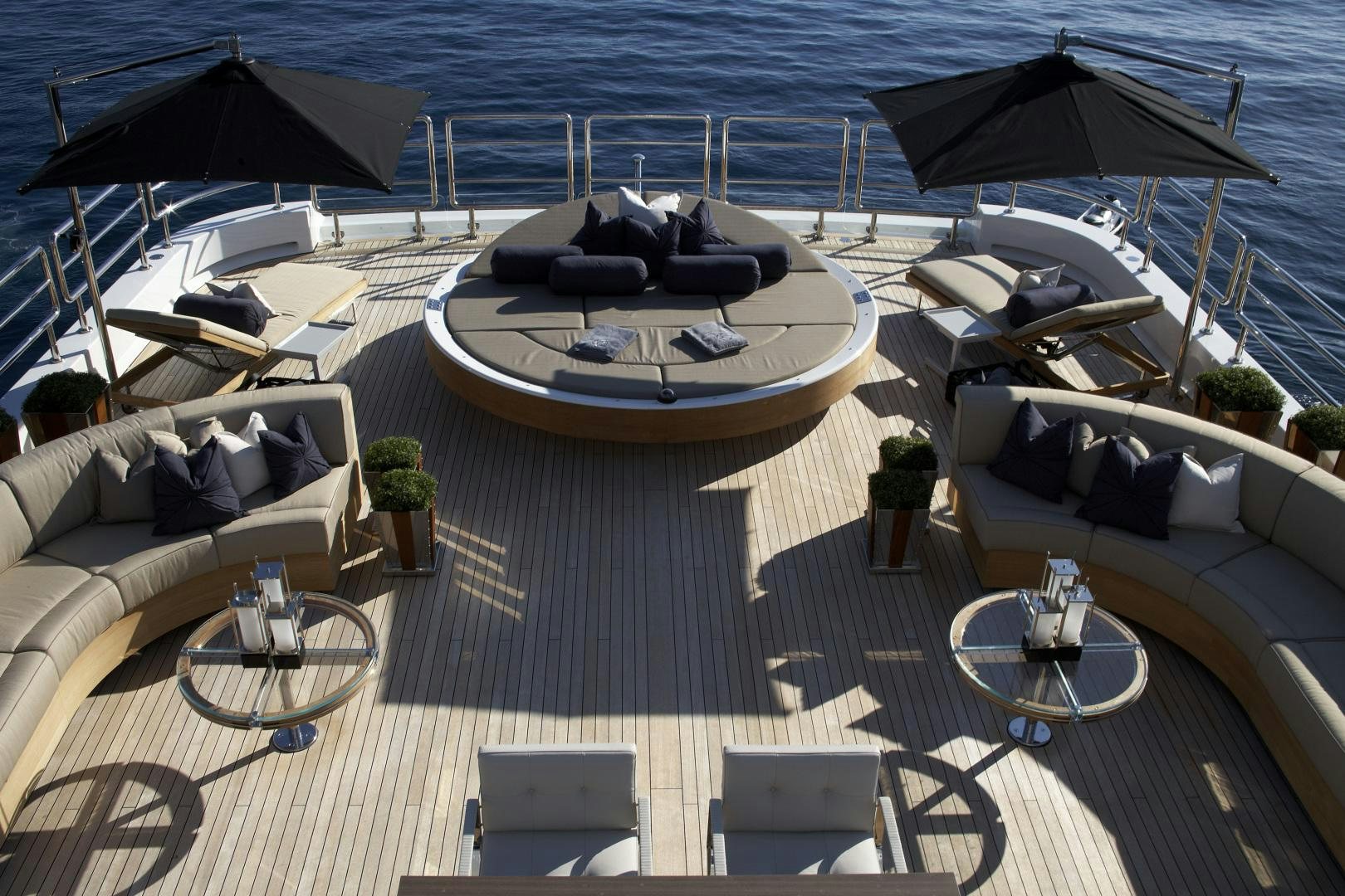 a deck with a boat and umbrellas on it aboard SEALYON Yacht for Sale