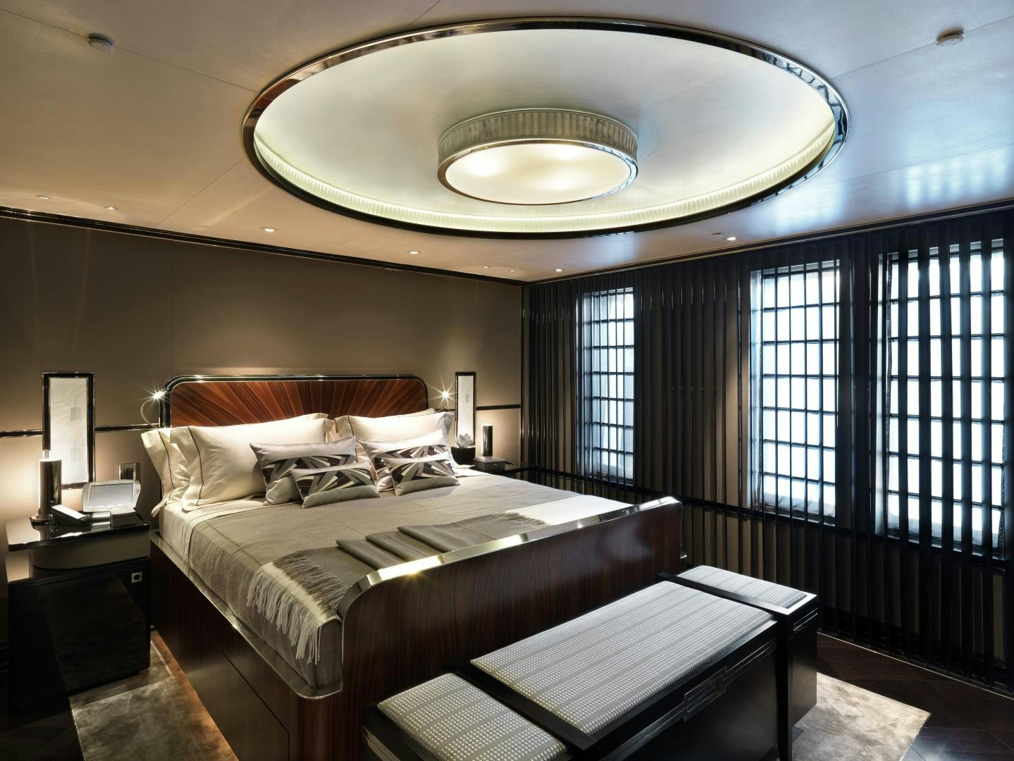 a room with a bed and a chandelier aboard SEALYON Yacht for Sale