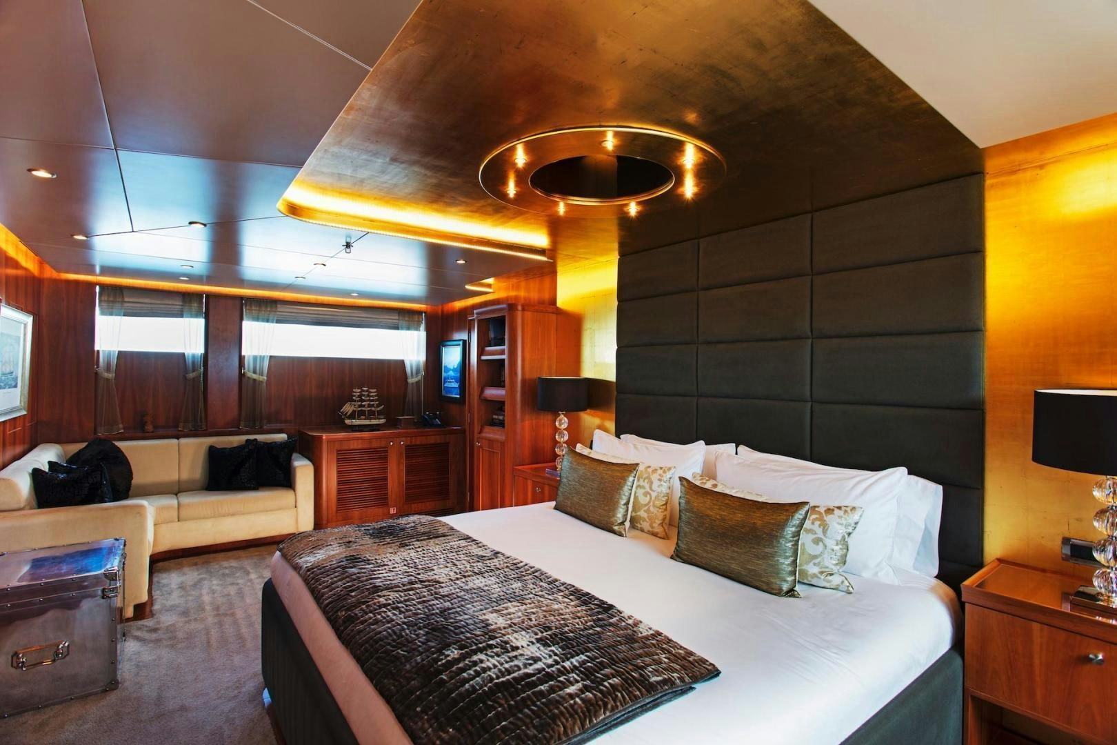 a bedroom with a bed and a couch aboard STAY SALTY Yacht for Sale