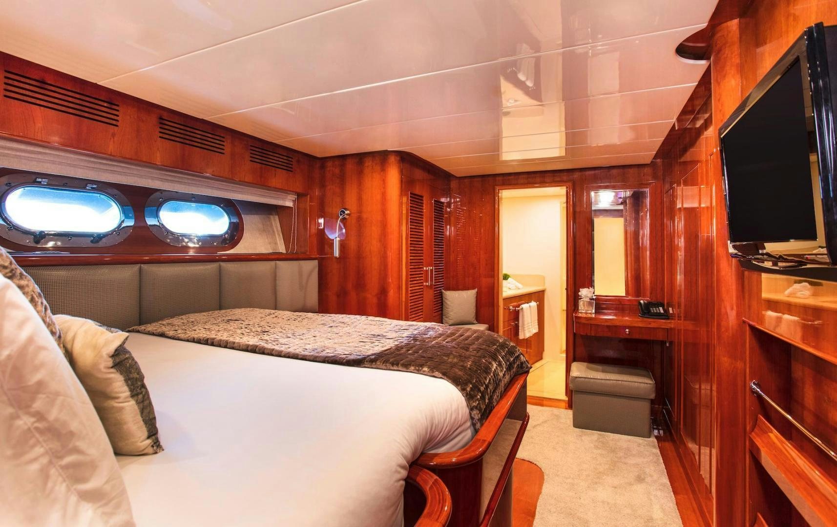 a bedroom with a bed and a television aboard STAY SALTY Yacht for Sale