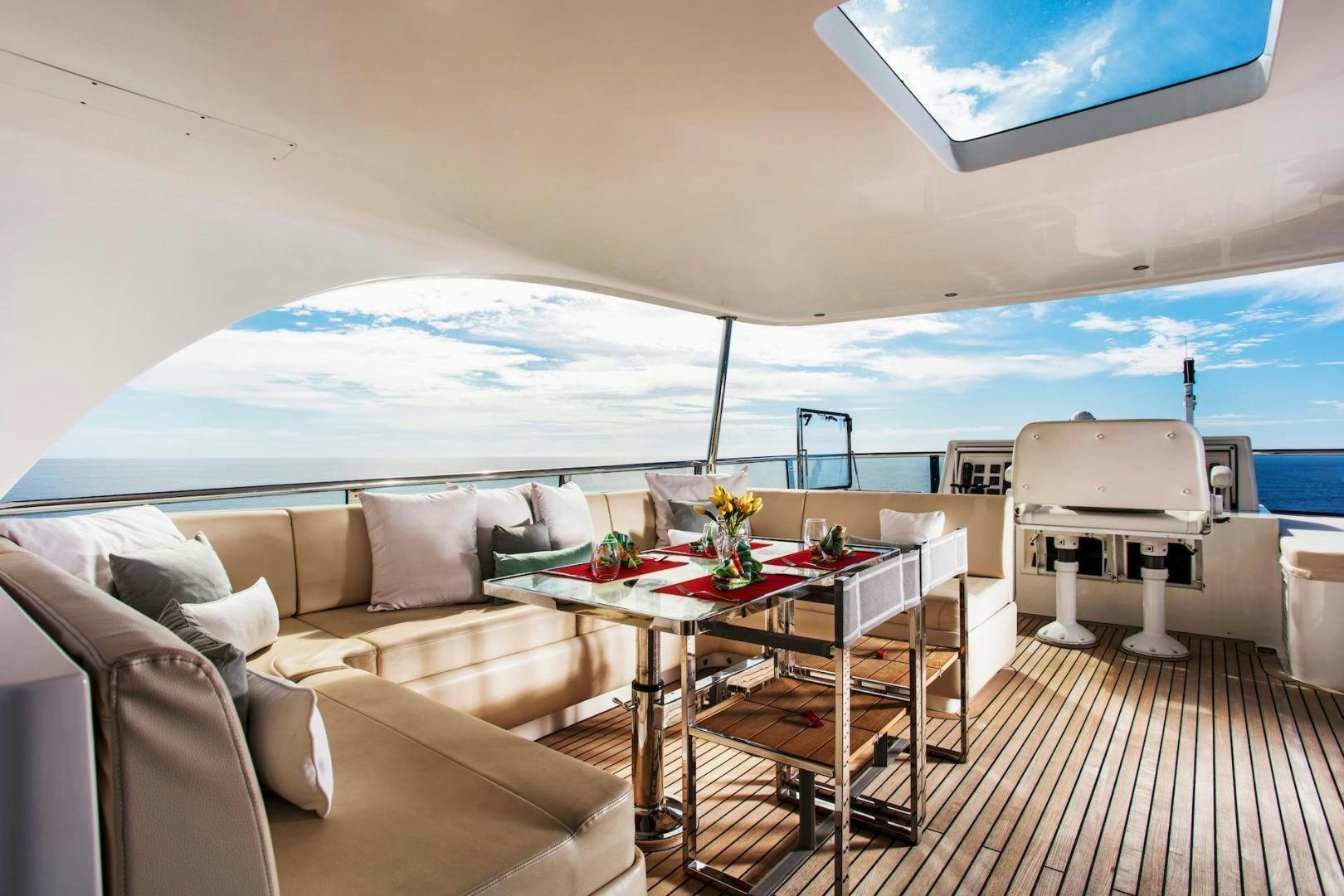 a room with a couch and a table and a large window aboard STAY SALTY Yacht for Sale