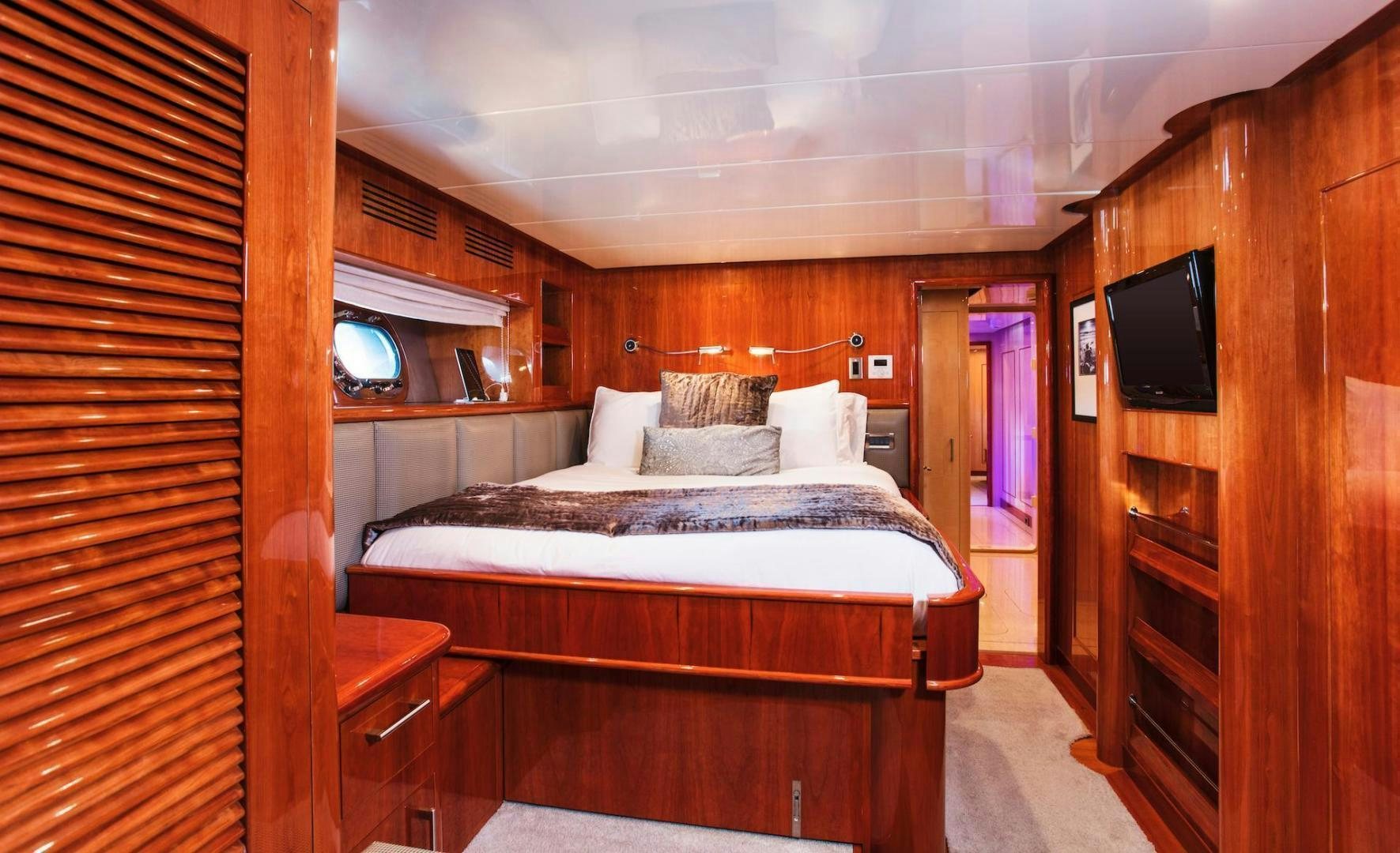 a bedroom with a bed and a television aboard STAY SALTY Yacht for Sale