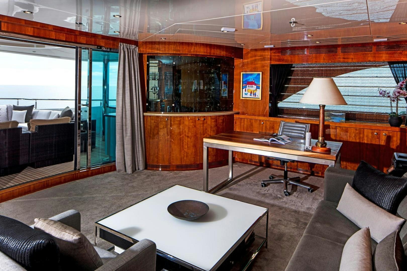 a room with a table and couches aboard STAY SALTY Yacht for Sale