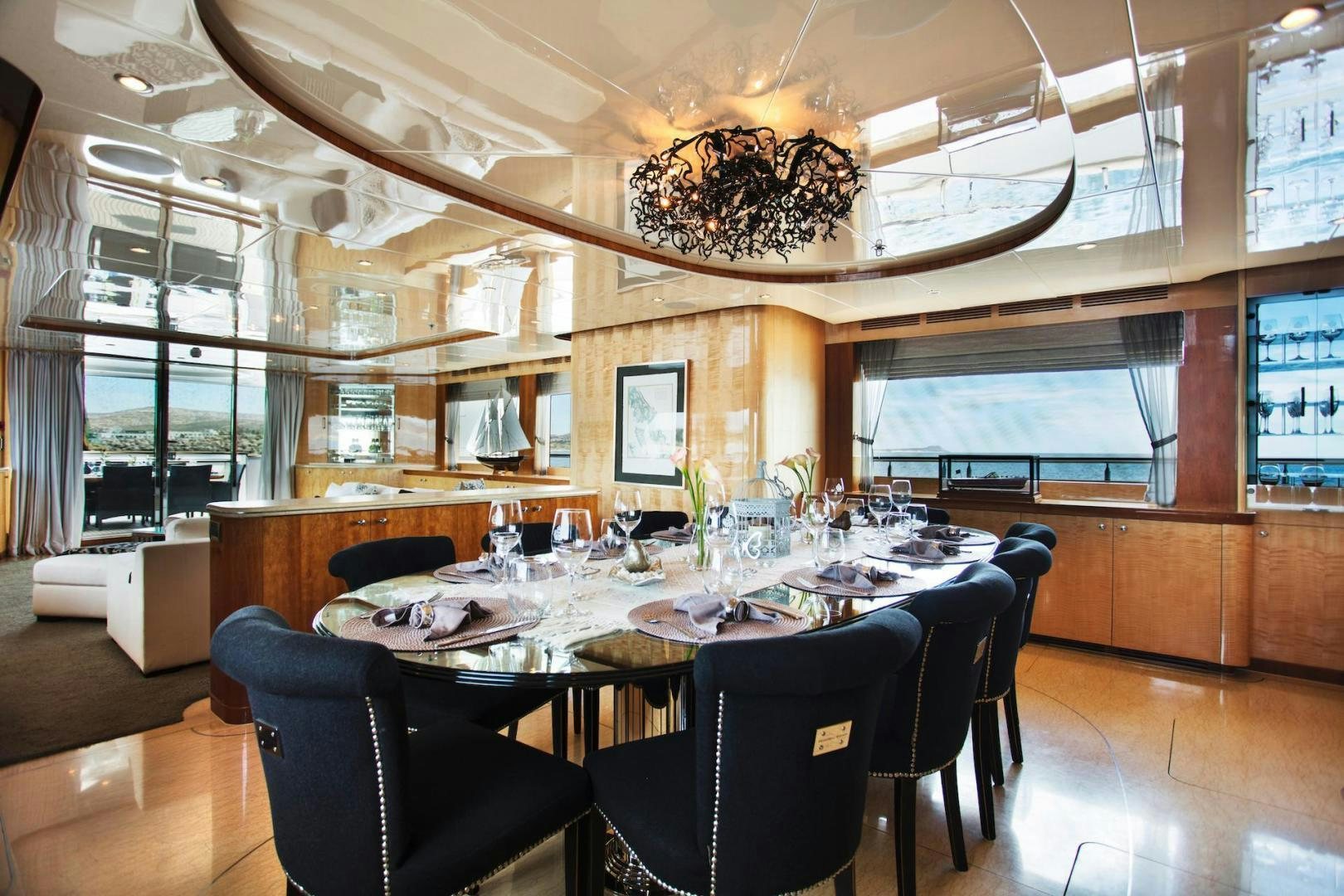 a large dining room with a chandelier aboard STAY SALTY Yacht for Sale