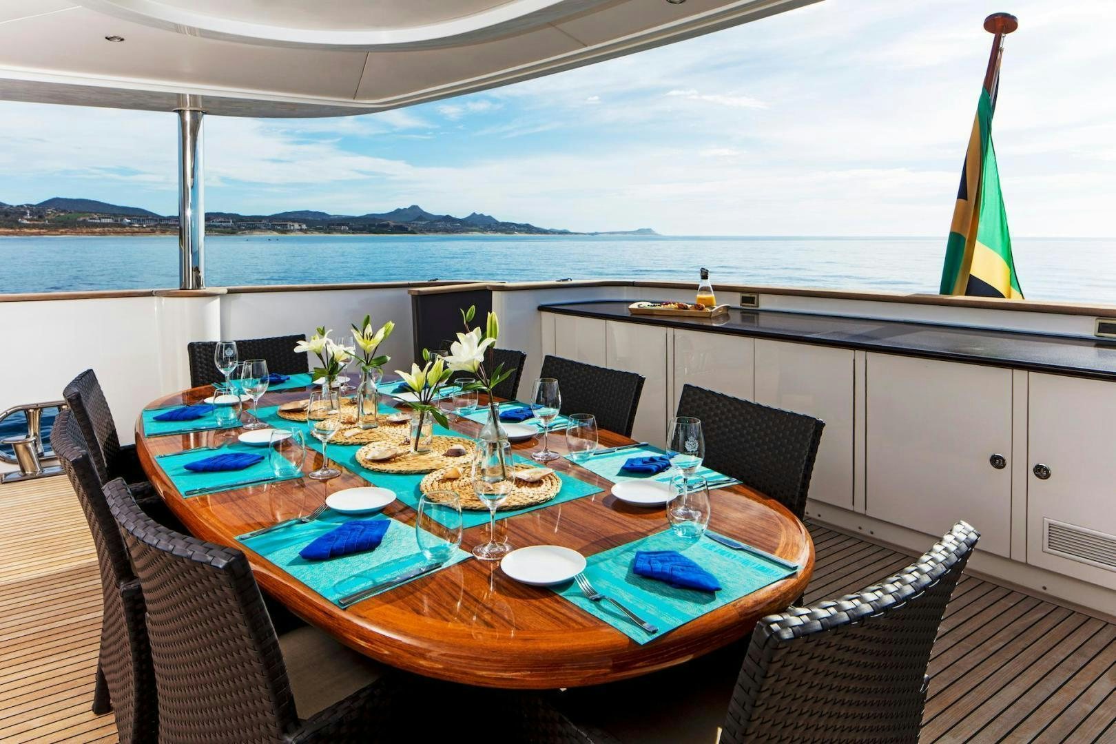 a table with plates and flowers on it aboard STAY SALTY Yacht for Sale