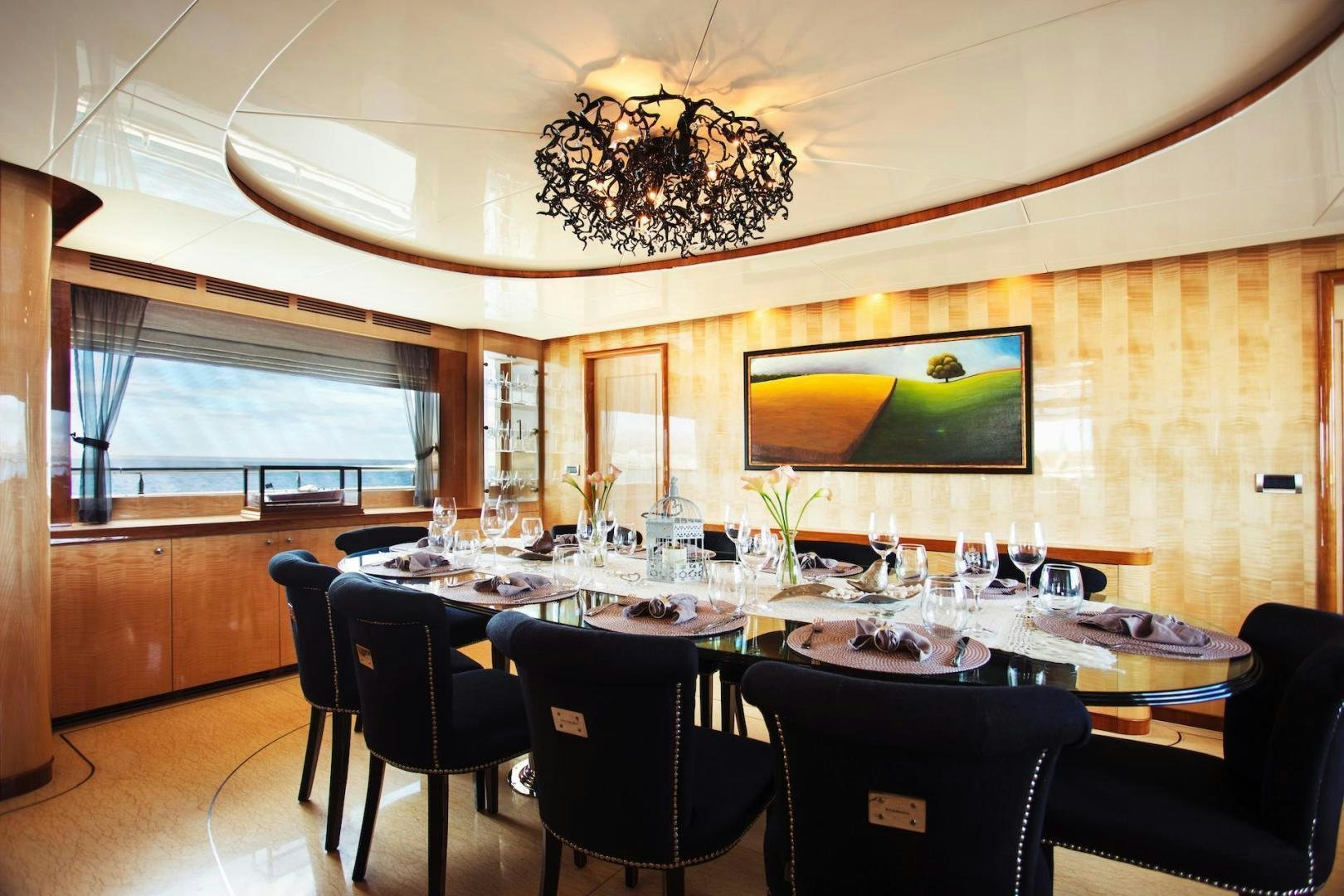a large dining room with a chandelier aboard STAY SALTY Yacht for Sale