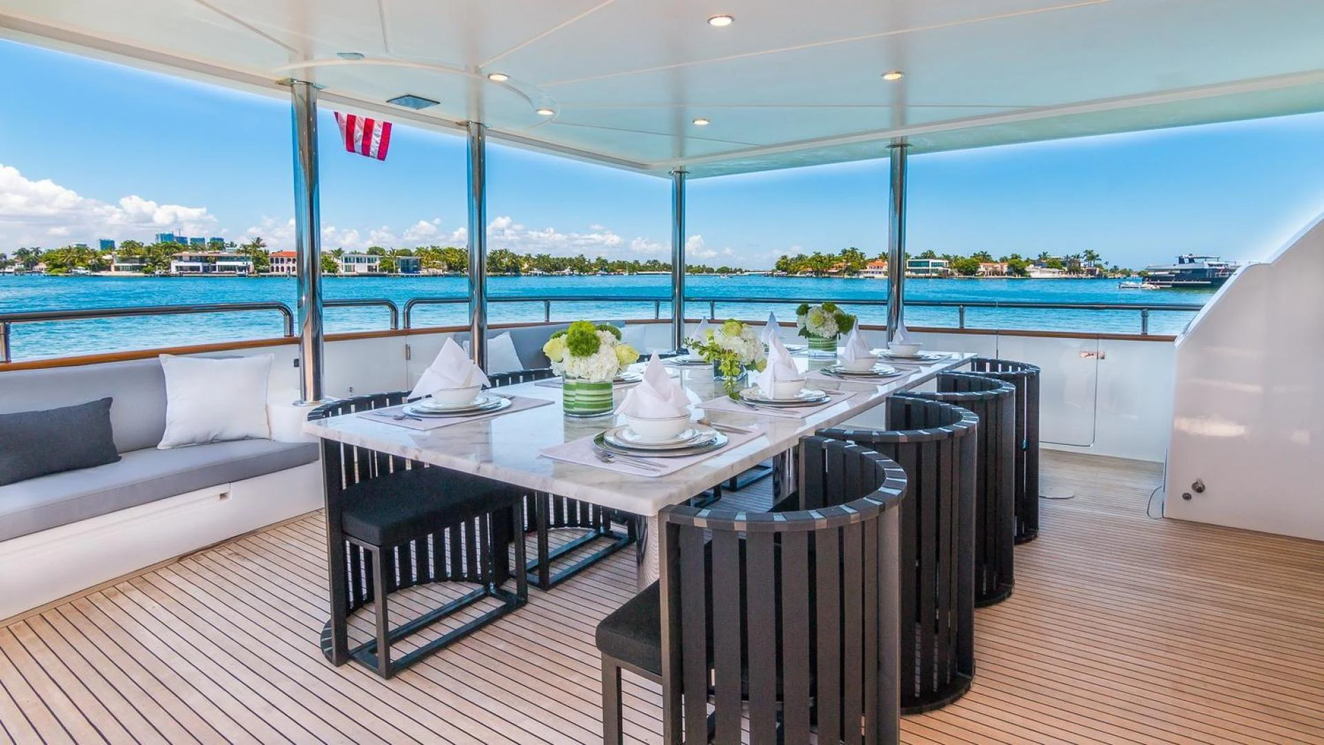 a table with chairs and a large window overlooking a body of water aboard NIRVANA Yacht for Sale