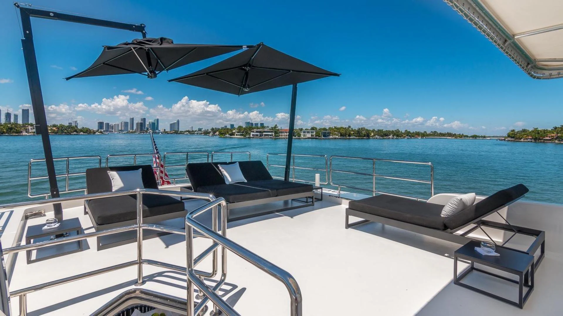 a lounge area with a large body of water in the background aboard NIRVANA Yacht for Sale