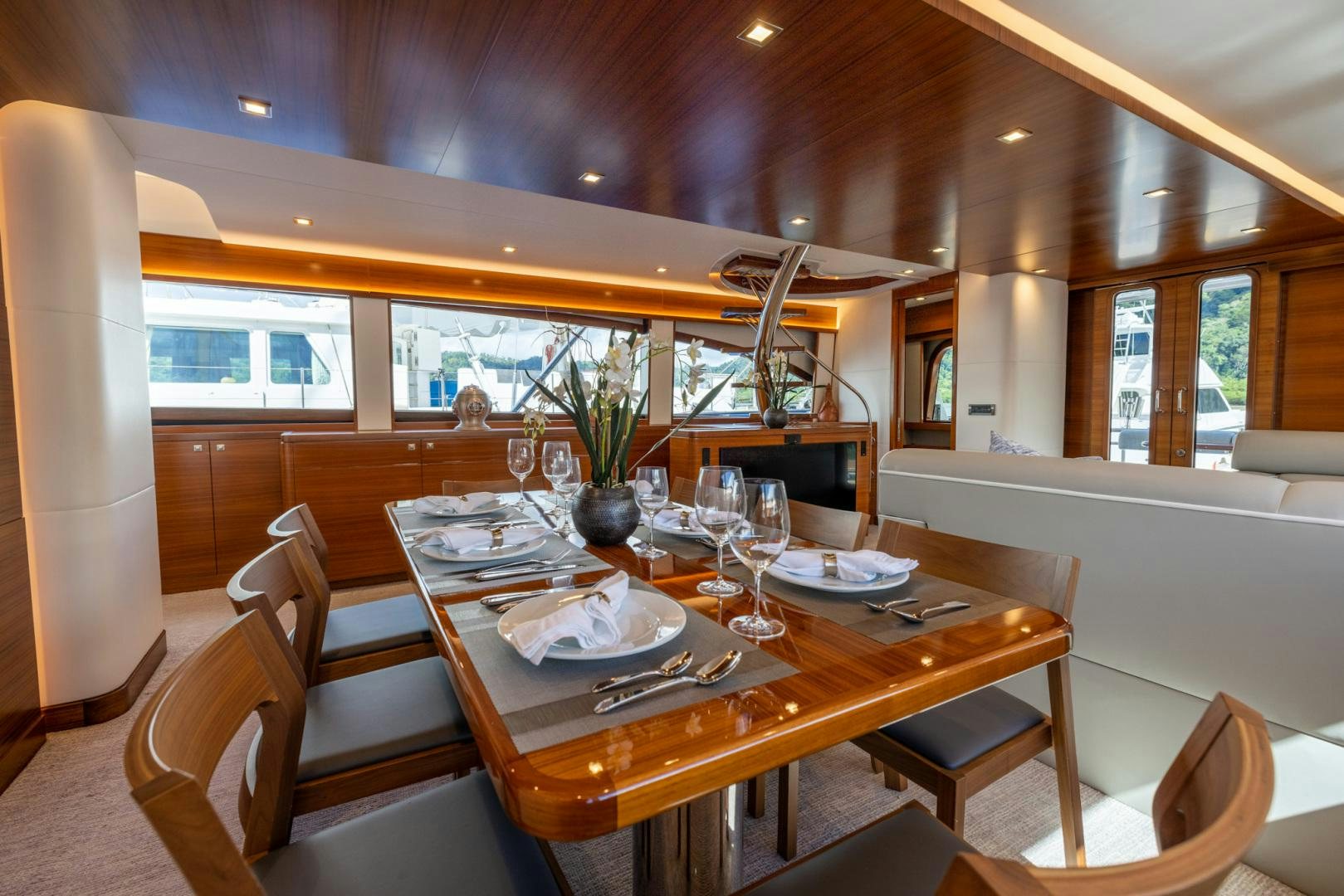a dining table with a set of chairs and a large window aboard BONNY READ Yacht for Sale
