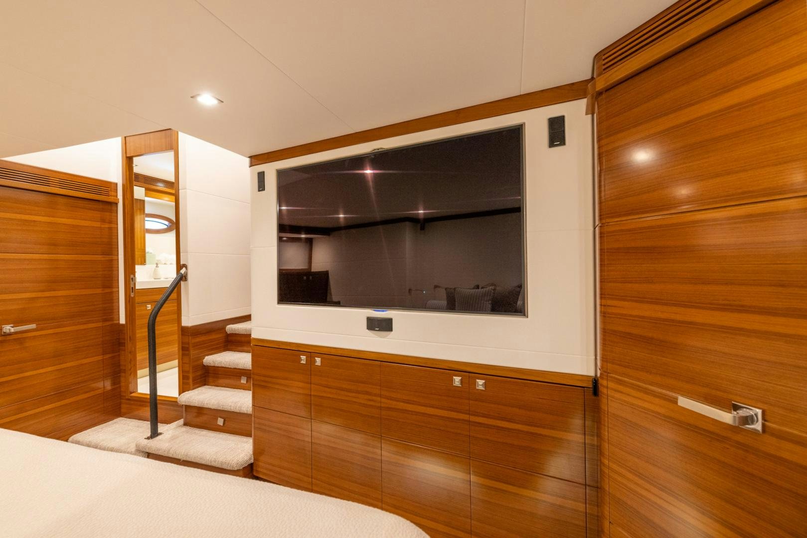 a room with a tv and a wood cabinet aboard BONNY READ Yacht for Sale