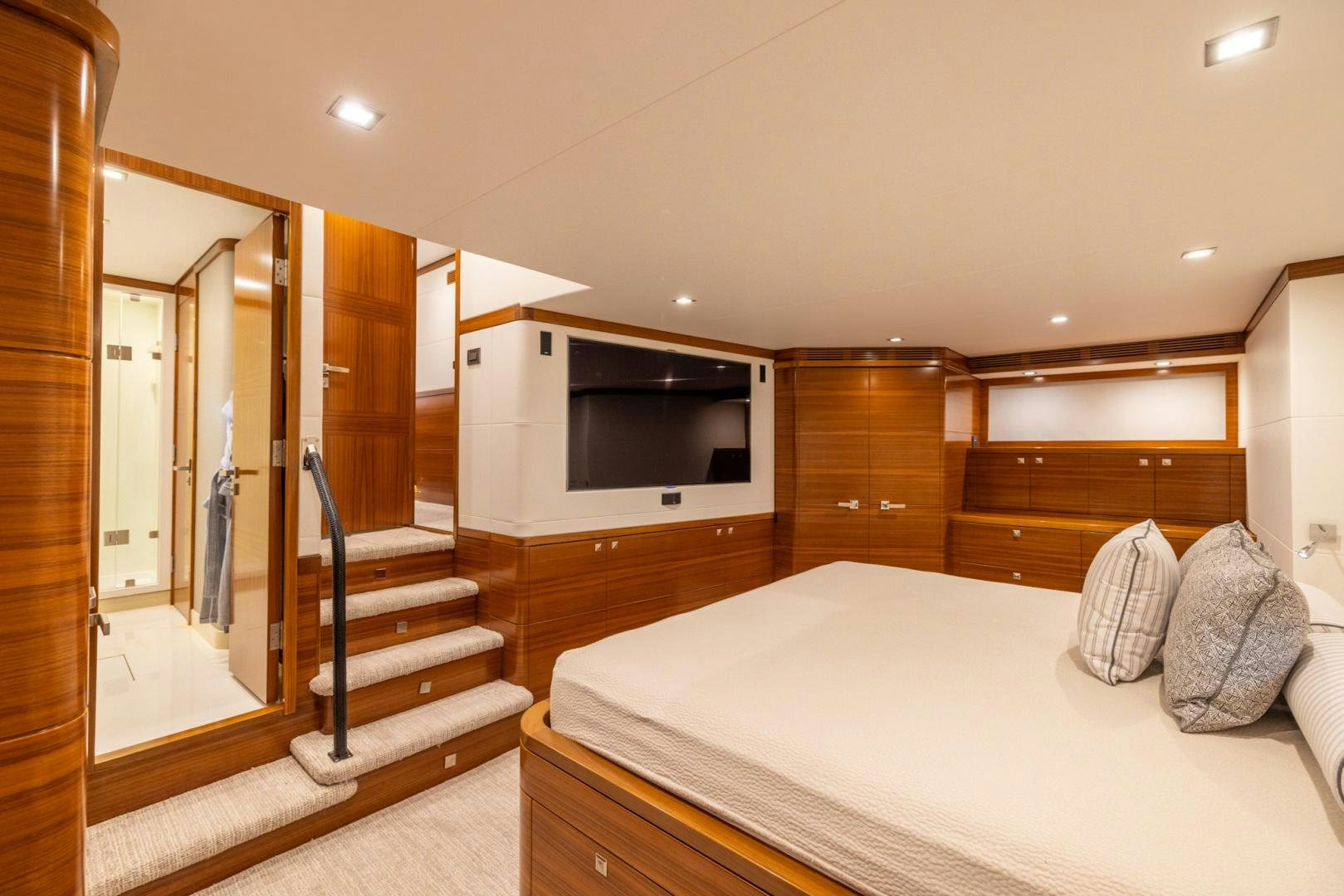 a modern looking bedroom with a large mirror aboard BONNY READ Yacht for Sale