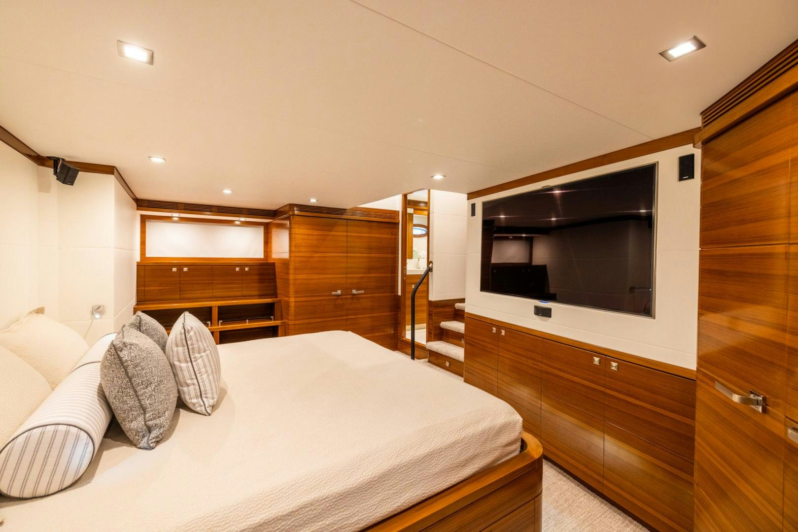 a bedroom with a bed and a wood cabinet aboard BONNY READ Yacht for Sale