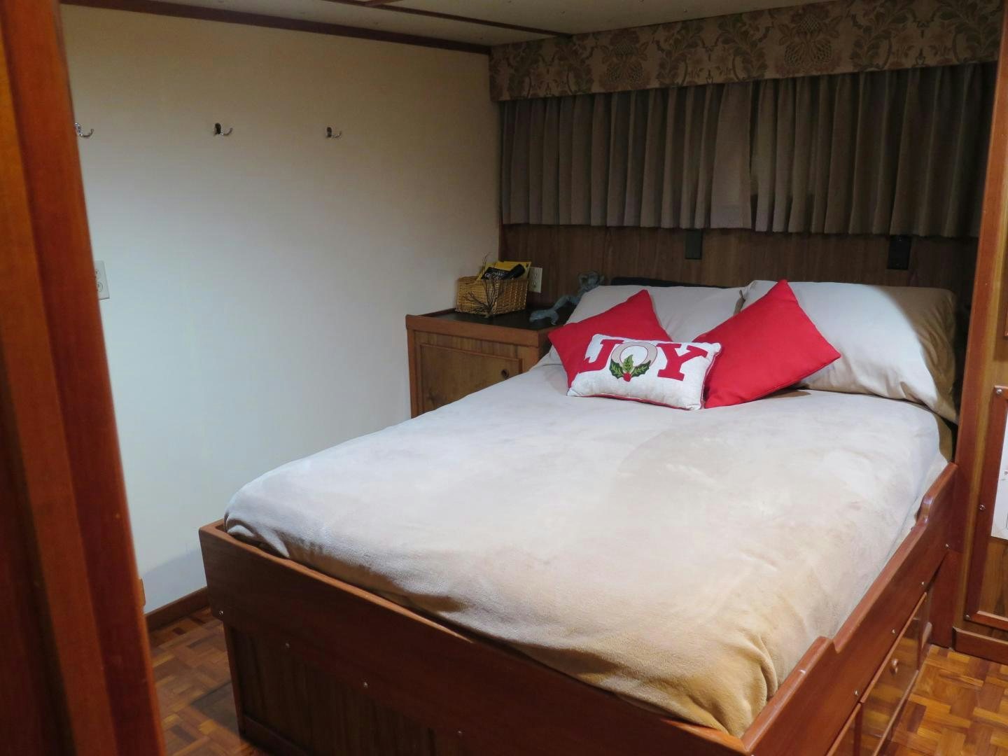 a bed with red pillows aboard WANDERER Yacht for Sale
