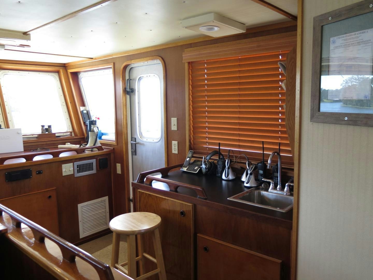 a kitchen with wooden cabinets aboard WANDERER Yacht for Sale