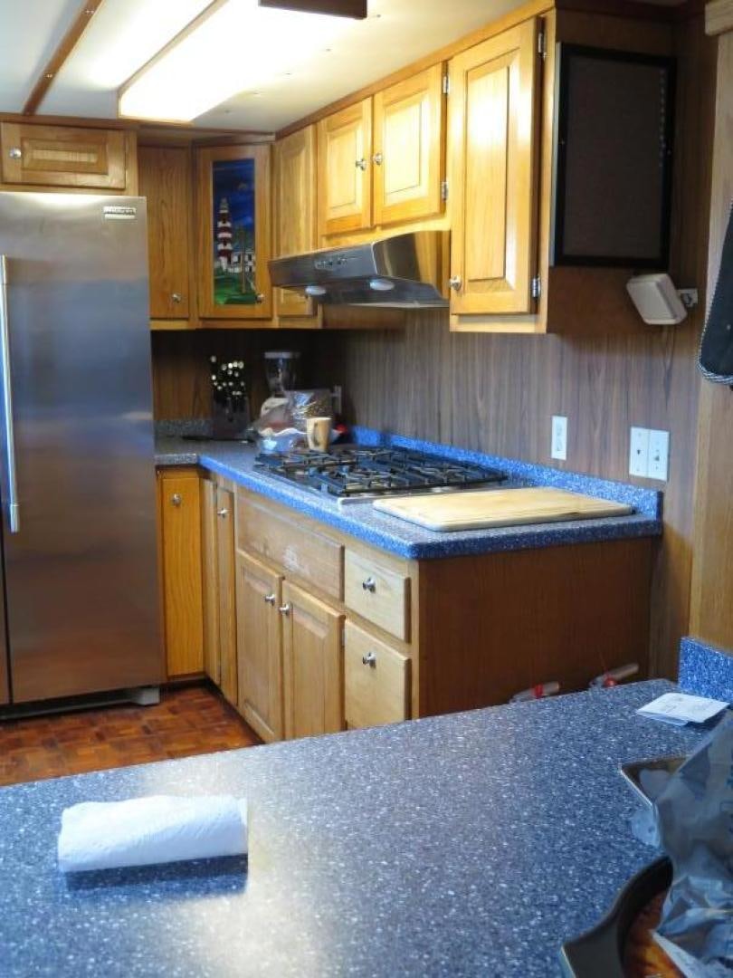 a kitchen with a stove and refrigerator aboard WANDERER Yacht for Sale
