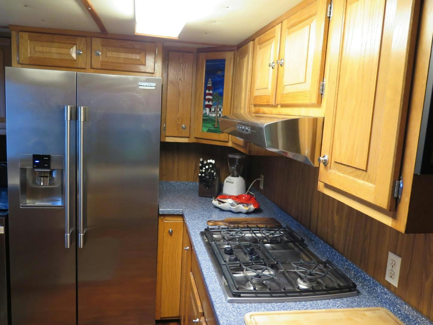 a kitchen with a stainless steel refrigerator aboard WANDERER Yacht for Sale
