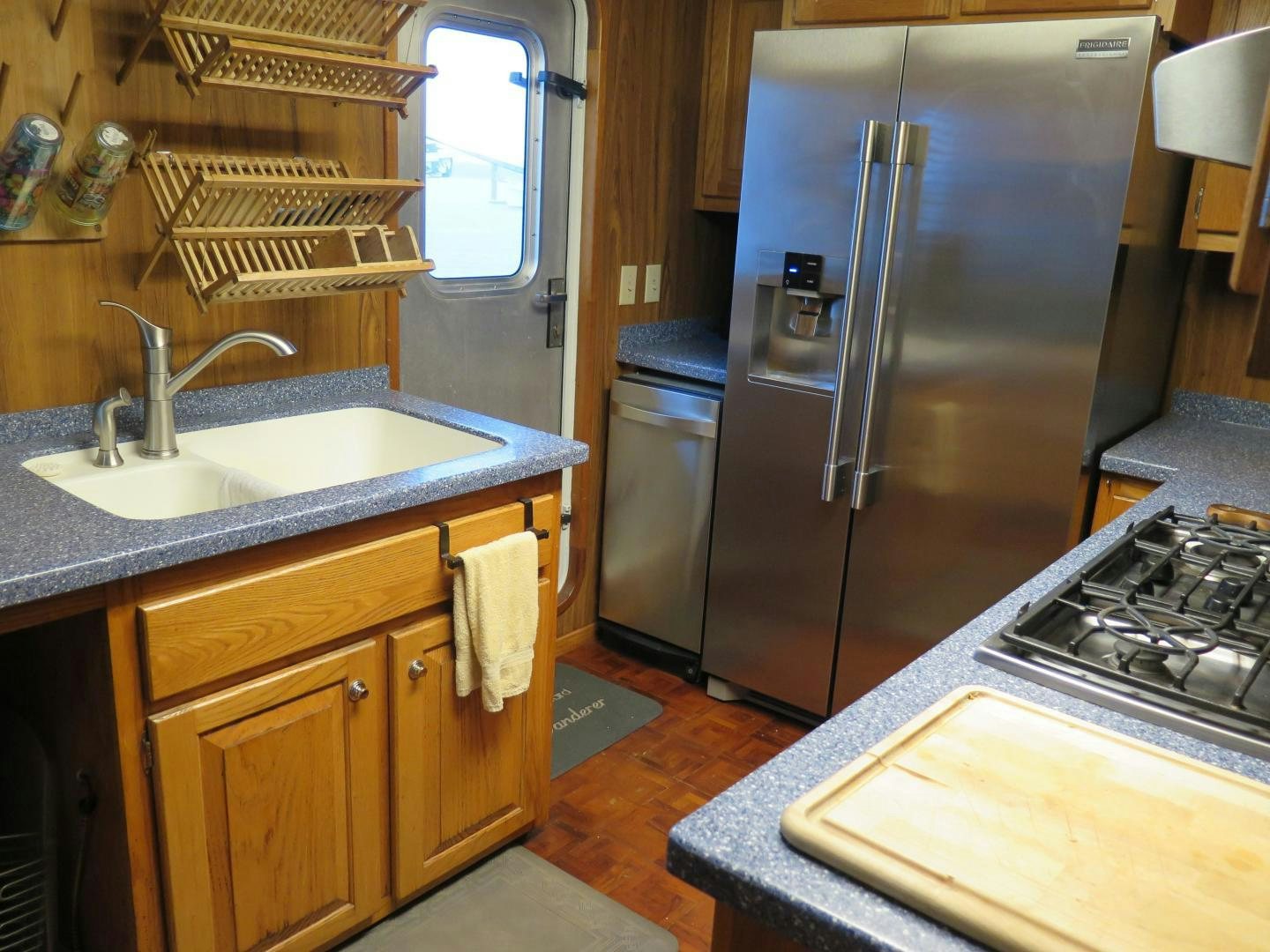 a kitchen with a stainless steel refrigerator aboard WANDERER Yacht for Sale